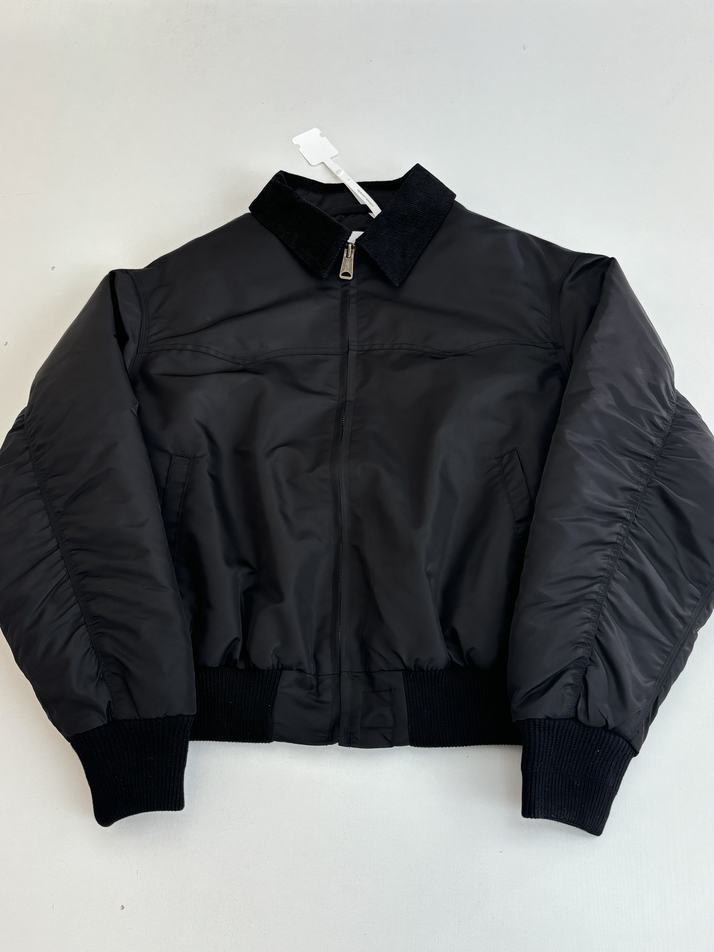 P320
Maison Margiel*/马吉拉MM6 基础素色拉链棉服夹克外套

这件夹克采用撞材质拼接工艺：衣身主体选用高密哑光尼龙面料，表面经细微压纹处理，兼具挺括感与防泼水性；领口则采用灯芯绒材质，通过精准包边工艺与衣身衔接，质感对比突出。衣身采用无绗缝充绒工艺，内部填充均匀蓬松，配合立体剪裁呈现松弛廓形；门襟选用定制金属拉链（配品牌标识挂坠），袖口与下摆为弹性罗纹收边，侧缝设隐形口袋，缝线采用同色系高韧韧度线迹，细节工整。整体设计兼顾复古质感与现代功能性，版型宽松适配多元穿搭场景。整体走线平直细腻，面料舒适柔软，颜色一致无色差 能与同款搭配营造时尚造型，驾驭各种场合，定制辅料，三标齐全，男女同款！

Size：46/48/50/52