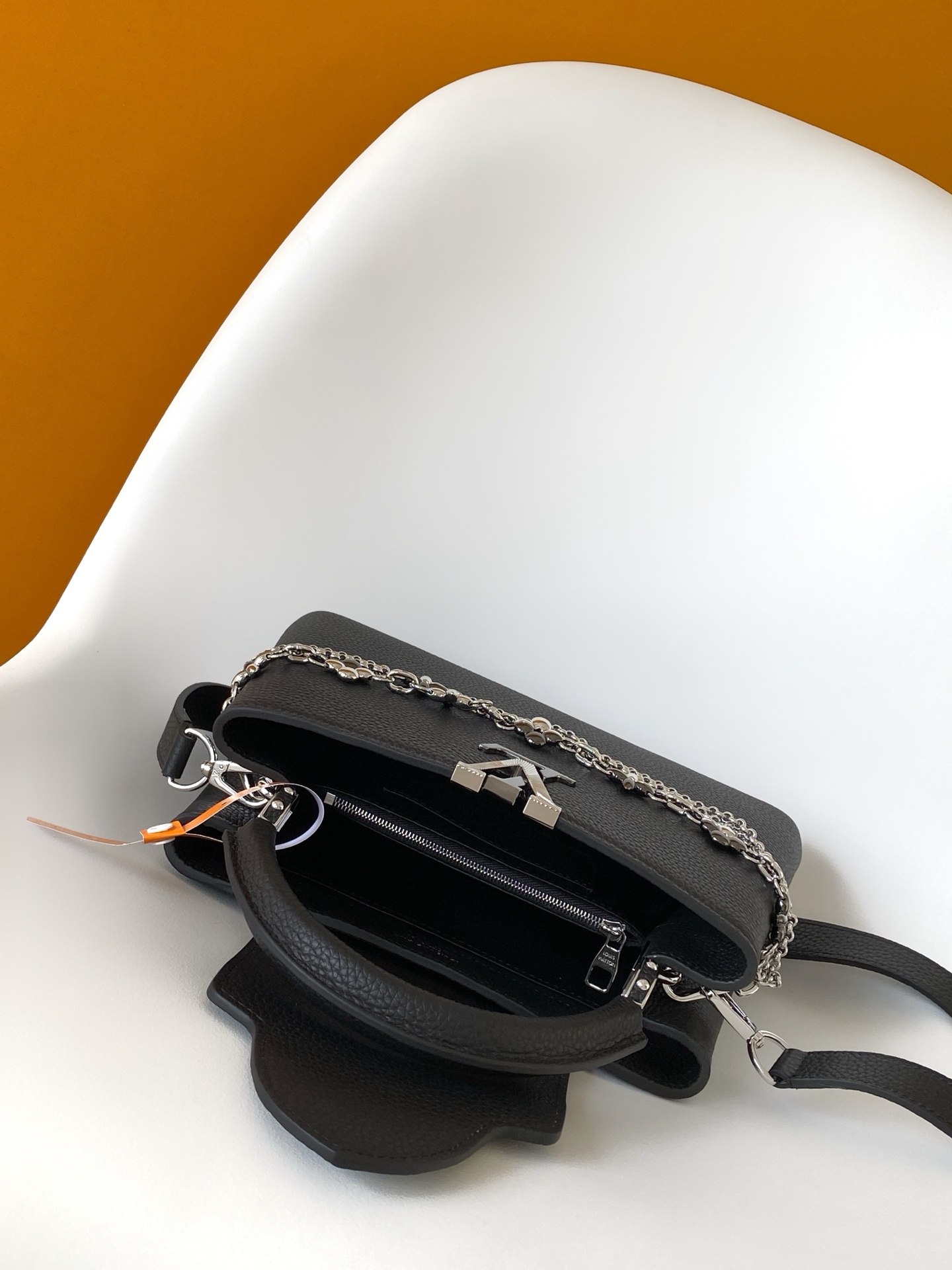 p1180💰M27035蓝色M27034紫红 M27039粉色 M26507西瓜红 M26351黑色白丽 M26814黑色 M26345米白横版Capucines Mini是一款适用于日间与夜晚场合的精致配饰。它采用由品牌珠宝启发的无限链设计，材质选用本季标志性深紫色色调的塔维尔隆皮革制成。双重镀锌五金细节，包括以放射状排列，反射光线的太阳纹工艺呈现的标志性LV首字母，增添了几分奢华感。可拆卸的肩带设计，让你既能将其作为肩包佩戴，斜挎于一侧肩头，亦可手提于顶部手柄处。
21x13.6x8厘米(长x高x宽)
27 x 17.3 x 9 (厘米) ((长 x 高 x 宽)
22 x 12 x 8 (厘米) ((长 x 高 x 宽)
横版白色
。托里昂皮革.Toryong皮革饰边。牛皮内衬
。金色与银色五金件
两种佩戴方式：可将翻盖收起或拉出。带一个平口袋的分隔内衬。底部四金属底座，用于保护
。存储：智能手机，Capucines紧凑钱包，钥匙。肩带：可拆卸，长度可调节
。肩背时最小肩带长度：46.5厘米
。肩背时最大肩带长度：54.0厘米手柄：简约