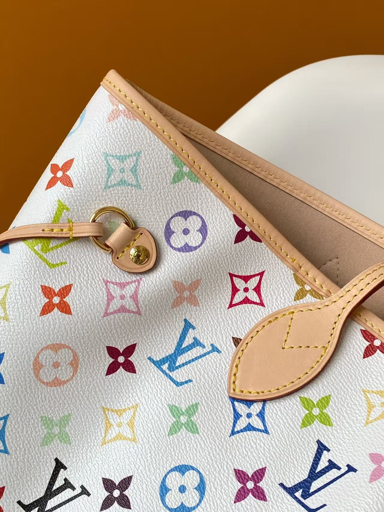 Louis Vuitton 本款 Neverfull 中号手袋取材出自路易威登 x 村上隆再版系列 选用缤纷 Monogram 涂层帆布塑造精巧构型