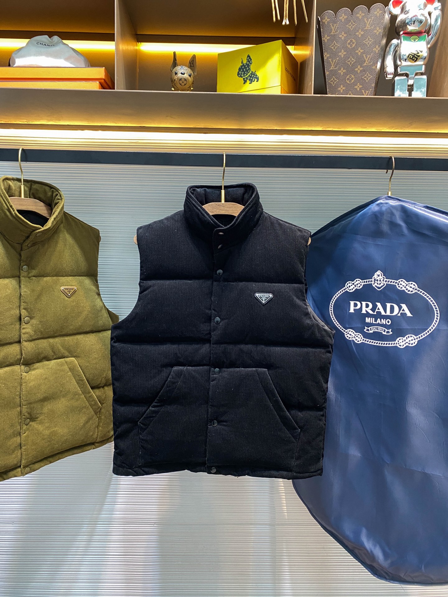 PRA25FW秋冬新款灯芯绒全棉拉链羽绒马甲，男女同款金属三角标徽章可收纳式连帽立领羽绒服马甲外套！贸易