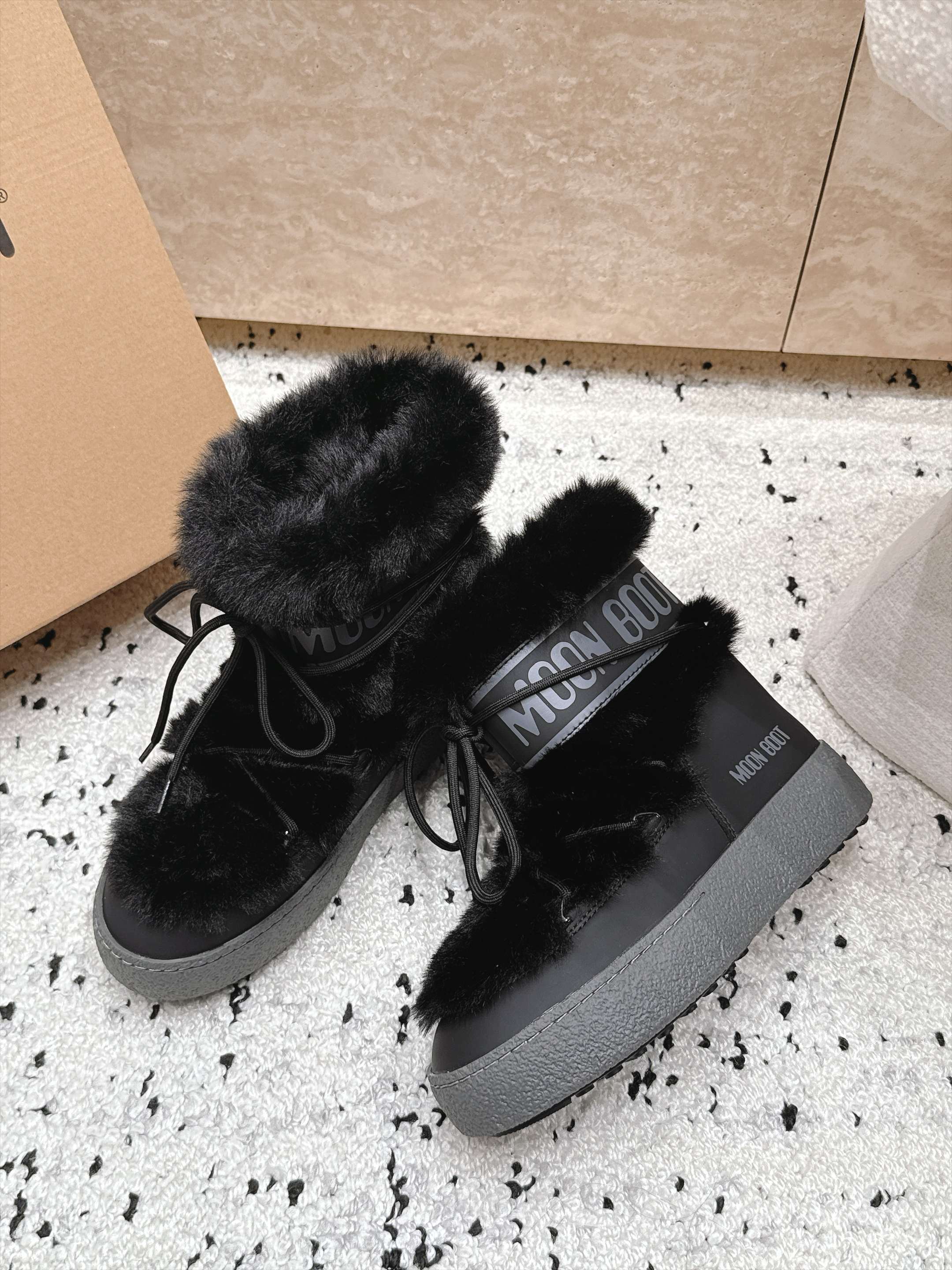 Moon Boot毛绒绑带雪地靴｜冬日甜酷保暖单品 Moon Boot这款毛绒雪地靴，妥妥是冬日氛围感担当，黑色和奶白双