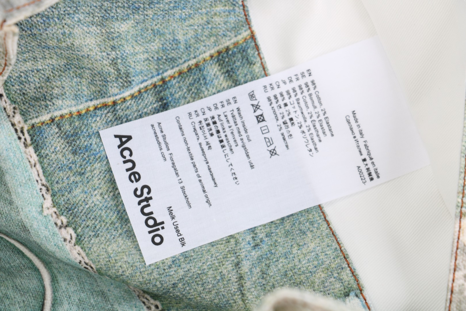 图片[7]-#Acne Studios 25Fw 蕾丝珍珠印花牛仔托特包 采用高密双股纱线织造，克重达420g/㎡，表面呈现粗粝斜纹肌理，同时通过预缩酵素洗处理确保尺寸稳定性，赋予包体挺括骨架感与抗变形性能，选用进口数码直喷机，实现1200dpi高清印花，通过6色纳米墨水层叠渗透技术，将“蕾丝裤”图案以微米级精度附着于帆布纱线间隙，形成立体浮雕触感。匹布印后经UV固化与硅油柔化处理，确保图案耐水洗、抗摩擦，使用兄弟BAS双针平缝机，配置16号钛涂层牛仔针与Tex 70高弹涤纶线，在包体侧缝及底部间距同步车缝双线，形成平行受力通道，分散承重压力。三次元回针加固，在拎手锚点、包角应力区采用电脑程式化回针，配合背面热熔胶衬垫，形成机械-化学双重复合固定，此设计通过材料科学与精密缝制技术的交叉应用，实现柔美意象与重型帆布机能结构的对立统一，体现ACNE对当代工艺美术化的极致追求 尺码：47×17×35-选品中心