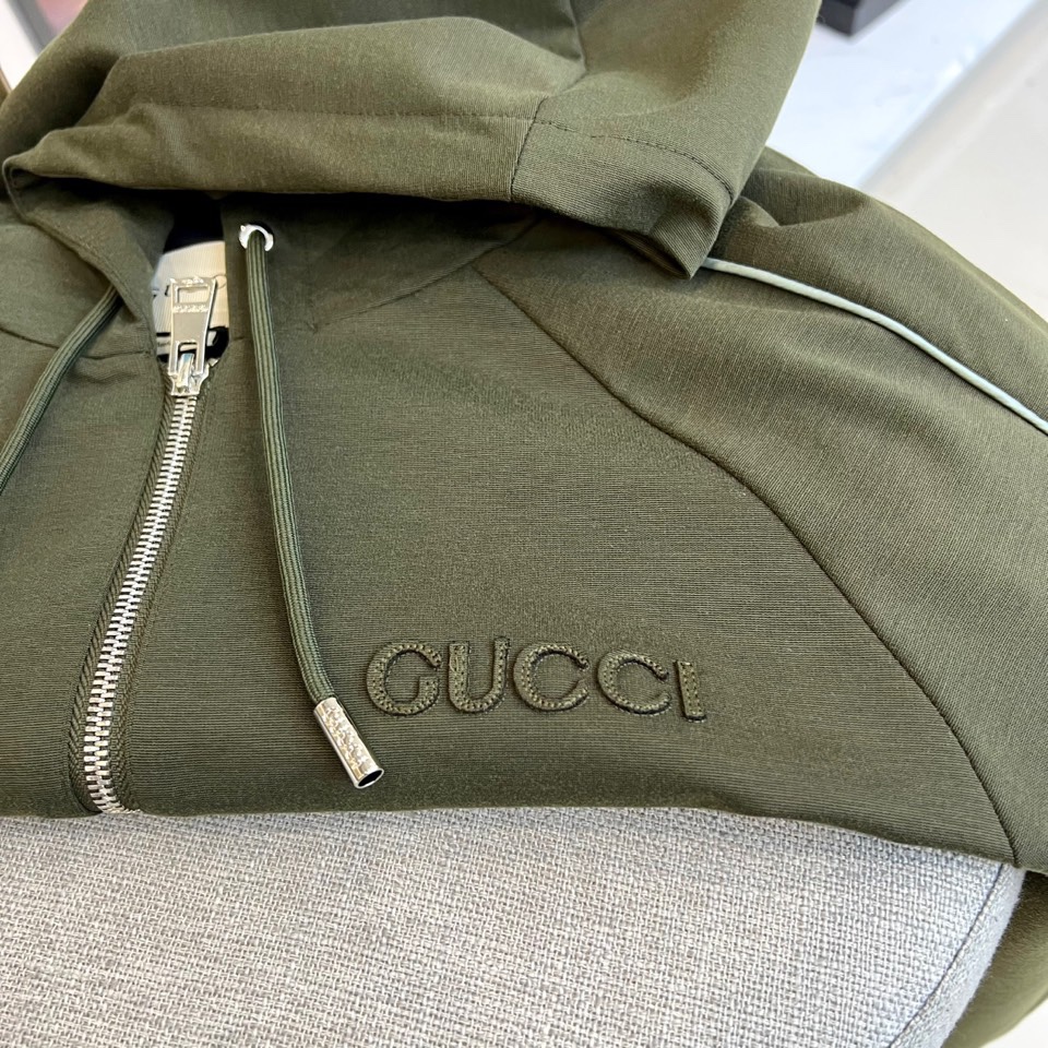 
GUCC古驰、25FW军绿连帽拉链外套，采用挺括棉质混纺面料，立体剪裁搭配抽绳连帽设计。胸前经典双G标