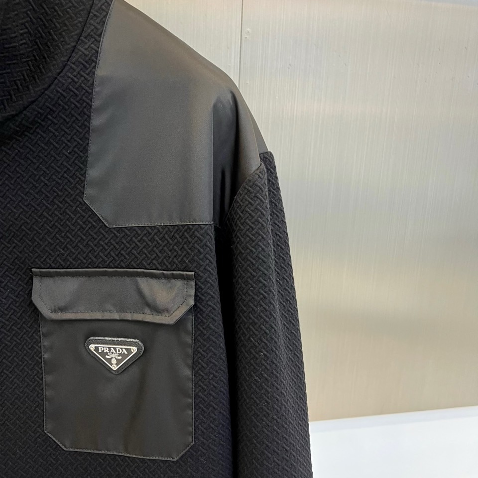 Prad普拉、25FW秋冬新品 黑色针织夹克外套。• 经典徽章加持：左胸翻盖口袋饰以PRADA标志性三角