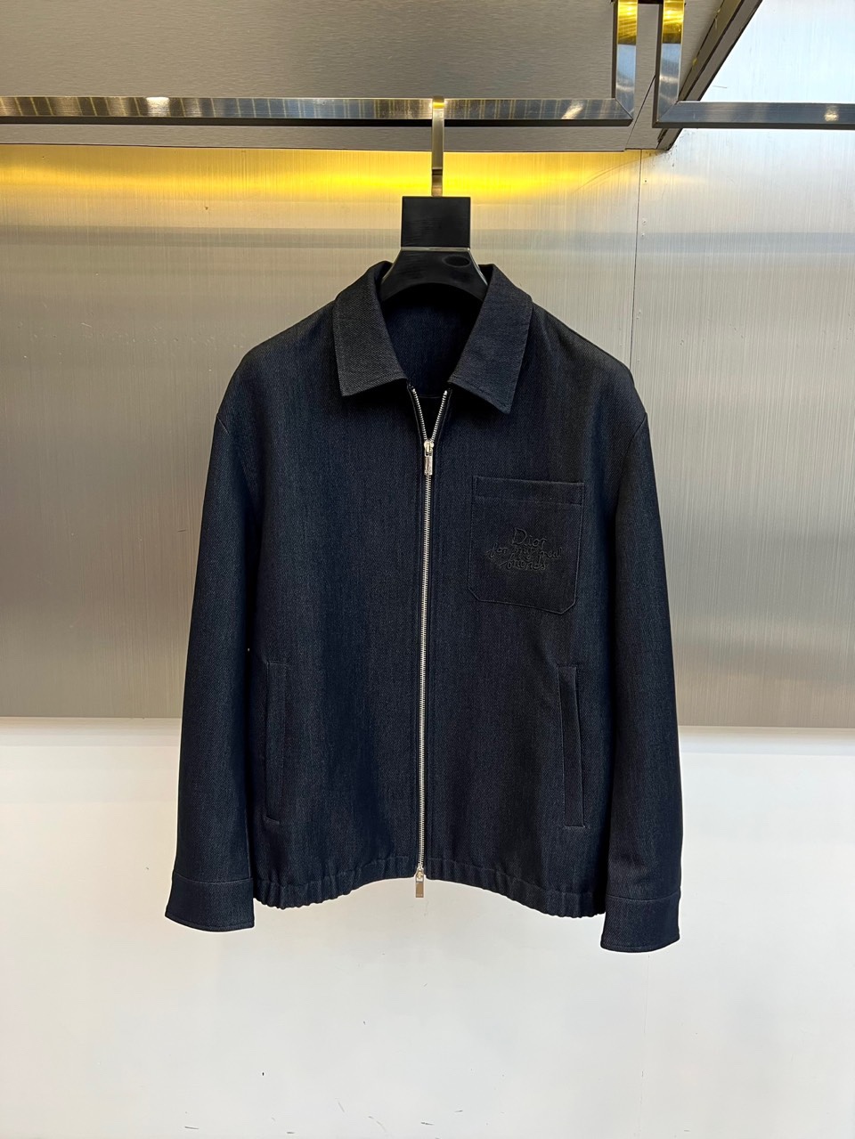 NO:529011,Dio, the new 2025 autumn and winter denim jacket, is made of deep indigo blue washing denim, and the fabric presents a delicate old texture and natural fading effect. The lapel design is cut by the same material, with a smooth silver metal zipper opening and closing on the front, and a classic flip pocket on the left chest, decorated with an imprinted 'CD' letter logo; the oblique socket pockets on both sides take into account practical functions and balanced outlines. The design ingenuity is hidden inside - the white 'DIOR' letter printing arranged in full version is in sharp contrast with the texture of the external denim, and the brand logo details can be seen on the inside of the silver zipper. The slim-fitting tailoring accurately outlines the body, and the slight wrinkle treatment at the elbows adds a retro charm.  The style perfectly combines French luxury genes and American retro work style. The washing indigo tone shows the unruly style, and the inner printed design reveals a low-key luxury attitude. This jacket can be paired with a white T-shirt and casual trousers to create a daily street look, and can also be stacked on the outside of the turtleneck sweater to present a layered fashion, perfectly adapting to the multiple scenes of walking from city to socializing at night. It continues Dior's ultimate pursuit of material craftsmanship, reinterpreting the modern spirit of high-end fashion houses through the classic carrier of denim, and providing both recognition and practical autumn and winter essential items for pioneers of the era who pursue quality and style. 48-56 (model 173, 143 catties upper body 50 yards), dior, dior, jackets & coats,tees, t-shirt, alexander wang19860909Dio迪奥、2025秋冬新品牛仔夹克,以深邃靛蓝色水洗牛仔布打造,面料呈现细腻的做旧肌理与自然褪色效果.翻领设计采用同材质立体剪裁,前襟配备顺滑的银色金属拉链开合,左胸处设经典翻盖口袋,饰有压印'CD'字母徽标；两侧斜插口袋兼顾实用功能与轮廓平衡.内里暗藏设计巧思——满版排列的白色'DIOR'字母印花与外部牛仔质感形成鲜明对比,银色拉链内侧可见品牌标识细节.修身剪裁精准勾勒身形,肘部微皱处理增添复古韵味. 风格上完美融合法式奢华基因与美式复古工装风,水洗靛蓝色调彰显不羁型格,内里印花设计则透露低调的奢华态度.这款夹克既能搭配白色T恤与休闲长裤打造日常街头造型,亦可叠加在高领针织衫外呈现叠穿时尚,完美适应从城市漫步到夜间社交的多重场景.它延续了Dior对材质工艺的极致追求,通过牛仔这一经典载体重新诠释高级时装屋的现代精神,为追求品质与风格并存的时代先锋提供兼具辨识度与实穿性的秋冬必备单品.48-56（模特173,143斤上身50码）,,dior,dior,jackets & coats,tees，t-shirt,alexander wang,Men's clothing