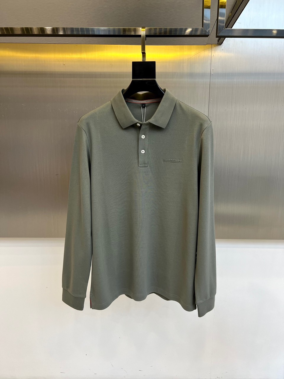 BUR巴宝莉、 2025秋冬新品长袖Polo衫，以经典翻领设计诠释现代英伦美学。领口配备三粒珠光白纽扣，