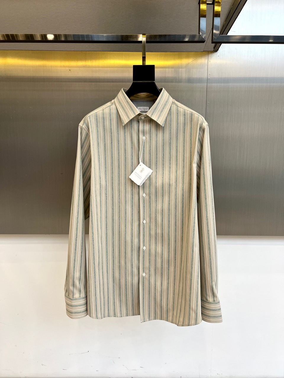 NO:595861,Brunello cucinelli-BC shirt When vertical stripes meet low-saturated blue-green tones, elegance has a new definition!  BC's classic long-sleeved shirt outlines a slender silhouette with delicate vertical lines, and has hidden contrasting edges on the collar and cuffs - details that are the aesthetic code of high-end players. Breathable fabrics are selected, taking into account both stiffness and comfort. White buttons are neatly arranged, and the texture is more prominent against the metallic light and shadow background; the chest  The tag tells the brand's persistence. Whether it is a workplace meeting or a weekend gathering, a BC allows you to take your time and show your taste in a low-key manner. From business to leisure, one piece can handle all-day scenes. 48-56 (model 173, 143 pounds, upper body size 50), brunello  cucinelli,shirts,alexander wang19860909Brunello cucinelli-BC衬衫当竖条纹遇见低饱和蓝绿调,优雅便有了新的定义！BC经典长袖衬衫,以细腻竖纹勾勒修长轮廓,领口与袖口暗藏撞色细边——细节处,皆是高阶玩家的审美密码.精选透气面料,兼顾挺廓与舒适.白色纽扣整齐排列,金属光影背景下更显质感；胸前吊牌诉说品牌坚持.无论是职场会议或周末雅集,一件BC让你从容不迫,低调展露品味.从商务到休闲,一件搞定全天场景.48-56（模特173,143斤上身50码）,,brunello cucinelli,shirts,alexander wang,Men's clothing