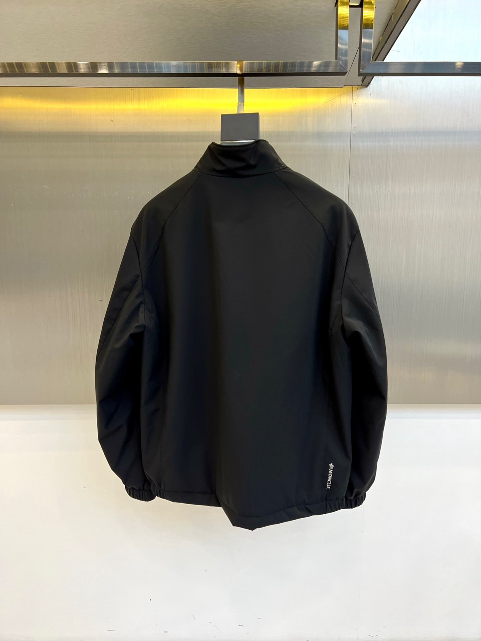 Mon蒙口、2025秋冬新品薄棉机能夹克，以极致纯黑重塑都市未来美学。采用高科技微光感面料打造立体廓形，