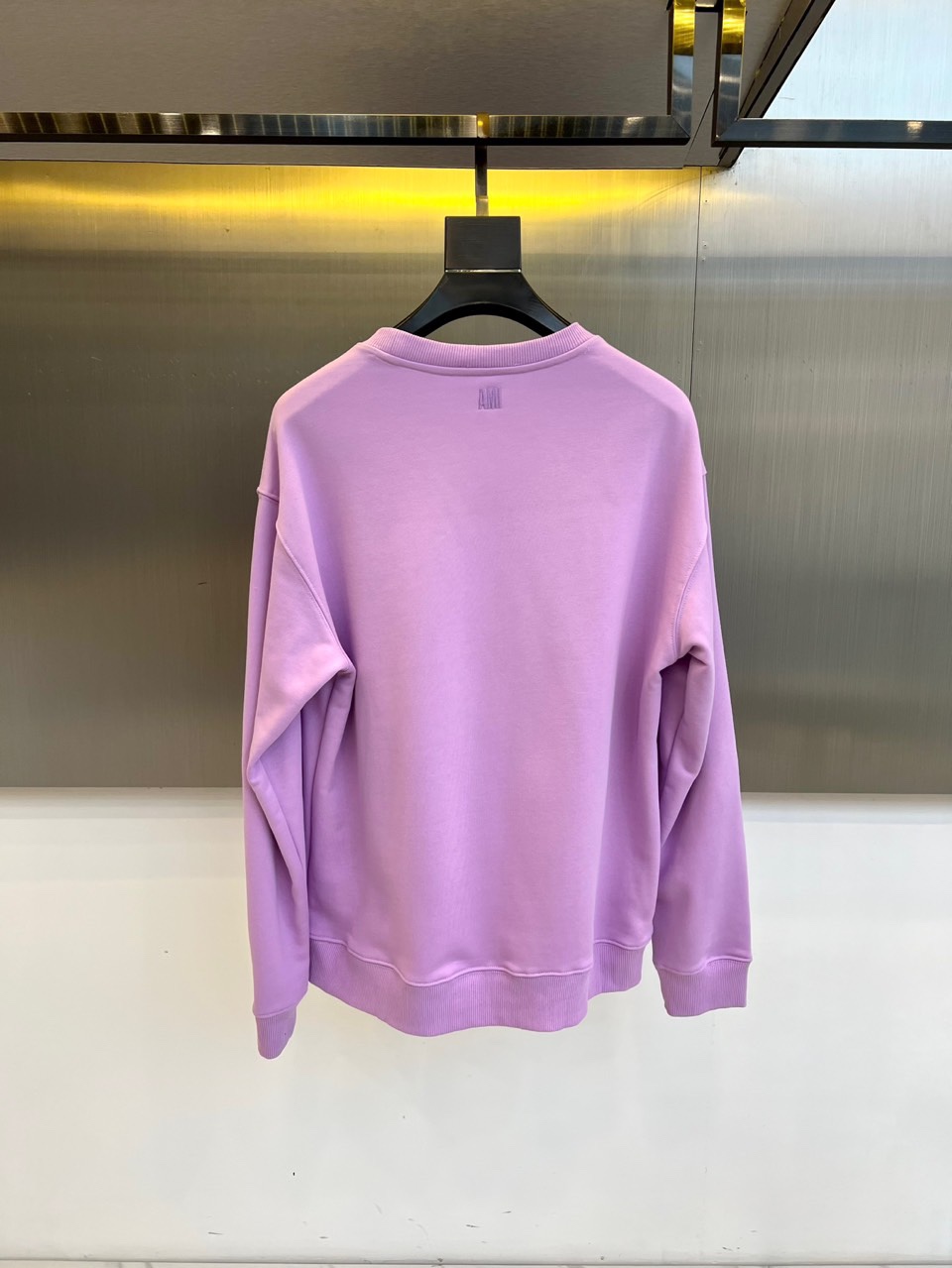 AMI 2025秋冬新品圆领卫衣，以纯净简约的白色为基调，打造秋冬清爽时尚感。胸前点缀品牌标志性红色爱心