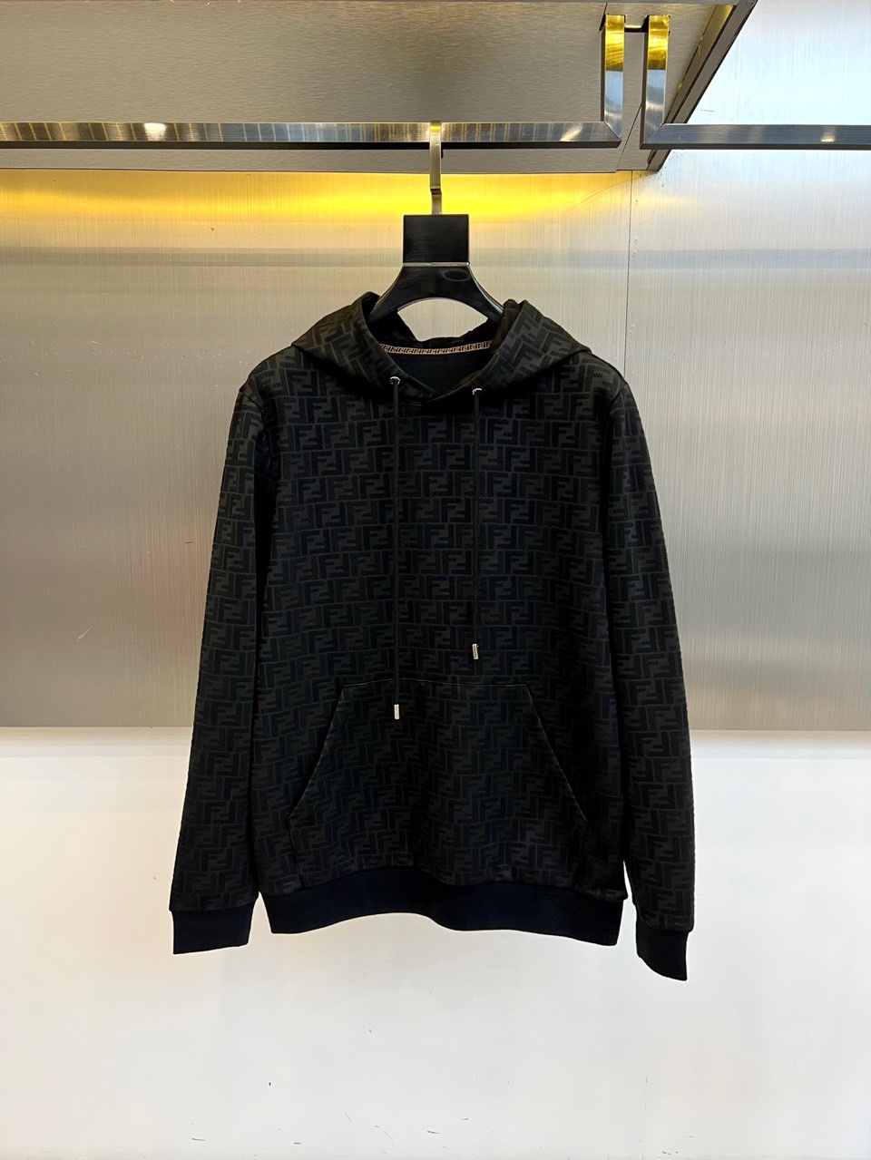 NO:564995,Fend Fendi's new hooded sweatshirt for autumn and winter uses the brand's iconic double F pattern on a brown background to demonstrate the perfect fusion of classics and trends. The hood is designed with a white drawstring to create a sharp visual contrast. It is equipped with practical patch pockets on the chest, and the cuffs and hem are ribbed in the same color to ensure a comfortable fit.  The fabric is made of high-quality cotton blend, and the inner fleece treatment gives the skin a soft touch. The oversized version takes into account both street feel and lazy style, and the double F pattern presents a delicate three-dimensional texture through jacquard technology. The brown color scheme is calm and advanced, and the white details inject vitality.   The overall style perfectly balances luxury genes and street aesthetics. It can be paired with leather items to show a cool style, or it can be paired with casual pants to create a lazy fashion. It can show its taste from daily outings to social occasions, interpreting Fendi's innovative spirit of transforming classic symbols into modern wardrobe language. The iconic double F pattern and detailed craftsmanship have become both autumn and winter.  A must-have item that is both recognizable and wearable. It is recommended to hand wash it in cold water to keep the pattern texture and shape crisp. 48-56 (model weighs 173,143 pounds, upper body size 50),, fendi, fendi, versace, hoodie, sweatshirts, hats, alexander  wang19860909Fend芬迪、秋冬新品连帽卫衣,以品牌标志性双F图案铺陈棕色系底色,演绎经典与潮流的完美融合.连帽设计搭配白色抽绳,形成鲜明视觉对比,胸前配备实用贴袋,袖口及下摆采用同色系罗纹收口确保贴合舒适. 面料选用高品质棉质混纺,内里起绒处理赋予肌肤柔软触感.oversize版型兼顾街头感与慵懒风格,双F图案通过提花工艺呈现细腻立体质感.棕色系配色沉稳高级,白色细节注入活力层次. 整体风格完美平衡奢华基因与街头美学,既能搭配皮革单品展现酷感型格,亦可与休闲裤装打造慵懒时尚.从日常出街到社交场合皆能彰显品味,诠释芬迪将经典符号转化为现代衣橱语言的创新精神.标志性双F图案与细节工艺,成为秋冬季节兼具辨识度与实穿性的必备单品.建议冷水手洗以保持图案质感与版型挺括.48-56（模特173,143斤上身50码）,,fendi,fendi,versace,hoodie,sweatshirts,hats,alexander wang,Men's clothing