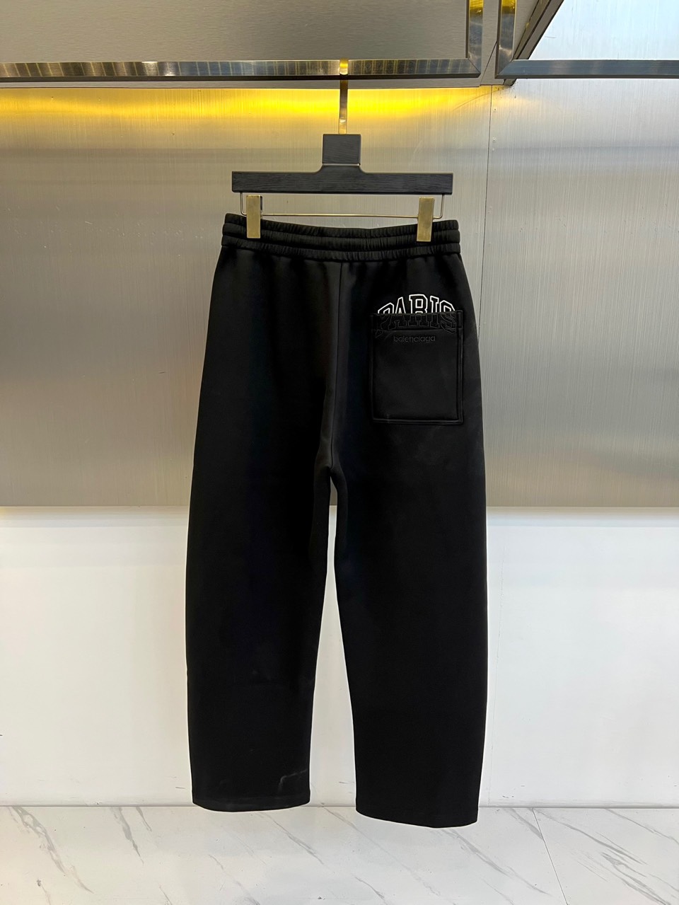 BALENCIAGA巴黎世家、2025秋冬新品男士休闲弯刀裤，这款休闲裤采用标志性弯刀版型设计，立体剪裁