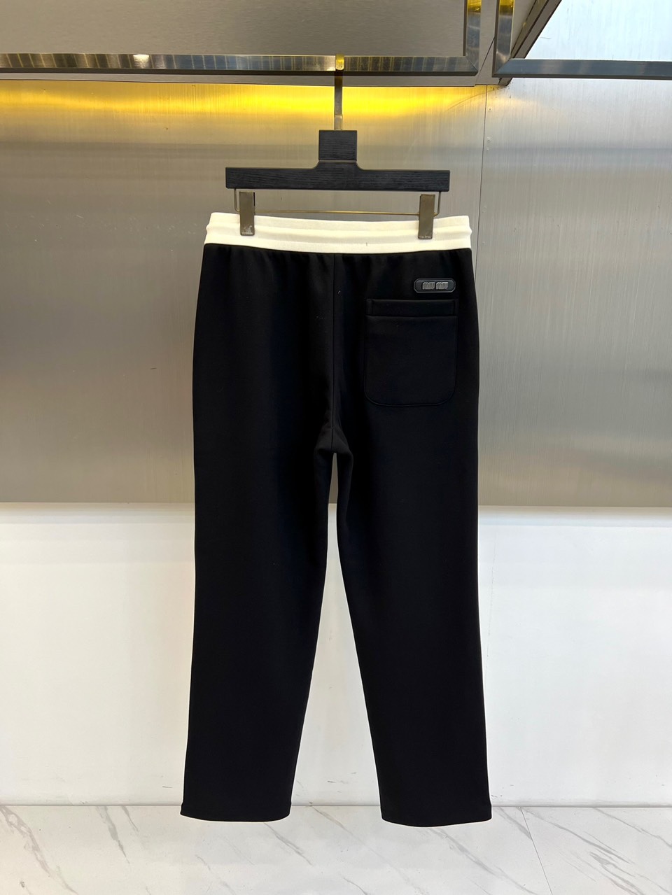 Miumiu谬谬、2025秋冬新品男士羊毛混纺休闲运动裤。这款运动裤采用标志性白色宽边腰头设计，搭配带有