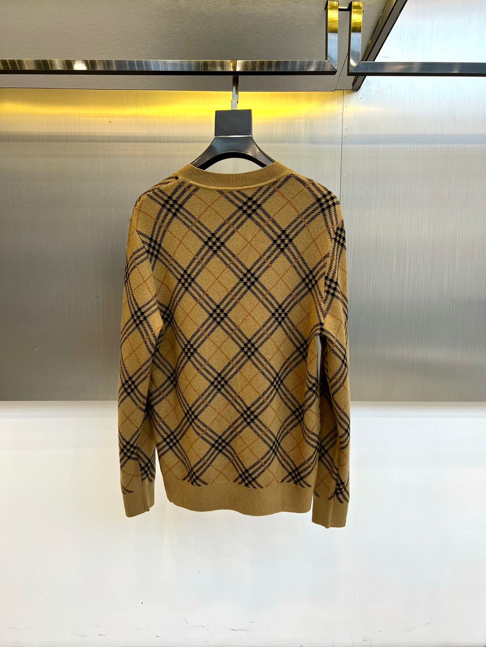 Bur巴宝莉、2025秋冬新品 BURBERRY经典格纹羊毛衫。这款暖棕色羊毛衫以品牌标志性格纹图案装饰