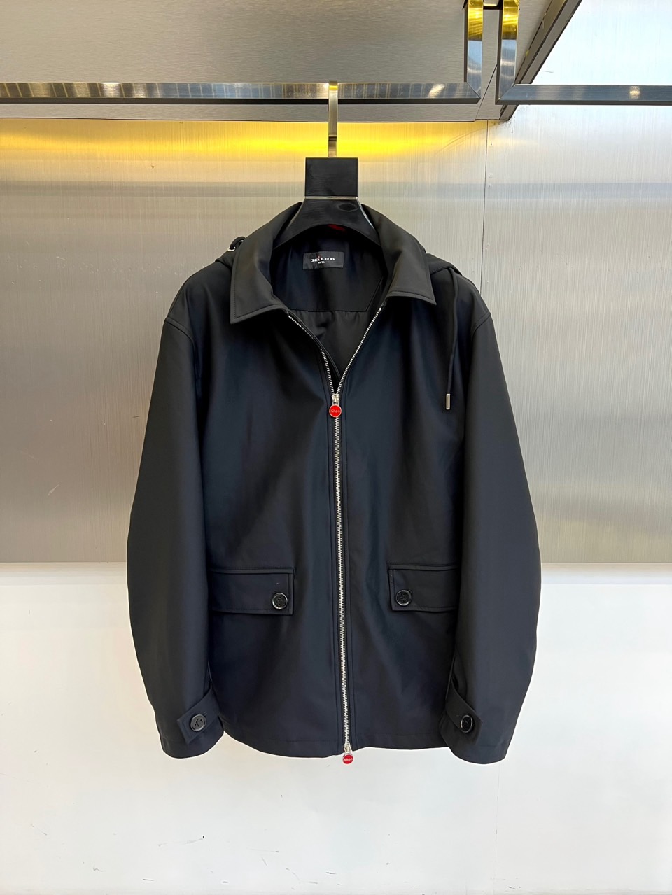 NO:726292,Kiton's new hooded jacket for autumn and winter after the new year. Interprets modern urban aesthetics with ingenious details and reshapes the calm posture of daily travel. It is suitable for multi-season wear and can easily control various styles of business and leisure. Three-dimensional tailoring technology shoulder line accurately modifies the body shape, and the hem is slightly gathered to highlight the neat silhouette. The details are ingeniously embellished with red metal zipper pullers to break the visual monotony, and the silver drawstring ring and black buttons create a texture collision. The hood is windproof and has an adjustable drawstring to cope with unexpected weather. The inside of the hood is made of skin-friendly materials  The multifunctional pockets and side pockets are designed with hidden seams to keep the appearance simple, and the capacity meets daily carrying needs. The fabrics are selected from wrinkle-resistant and wear-resistant materials to maintain a crisp fit after repeated wear. 48-56 (model weighs 173,143 pounds, upper body size 50),, jackets & coats, hats,19860909年后 Kiton 奇顿、秋冬新品连帽夹克.以匠心细节诠释现代都市美学,重塑日常出行的从容姿态.适配多季节穿搭,轻松驾驭商务休闲多种风格  立体剪裁工艺肩线精准修饰身形,下摆微收凸显利落轮廓  细节匠心点缀红色金属拉链头突破视觉单调,银色抽绳环与黑色纽扣形成质感碰撞  连帽防风设计可调节抽绳应对突发天气,帽内采用亲肤材质  多功能口袋侧兜暗缝设计保持外观简洁,容量满足日常携带需求  精选面料抗皱耐磨材质,经多次穿着仍保持挺括版型 48-56（模特173,143斤上身50码）,,jackets & coats,hats,,Men's clothing