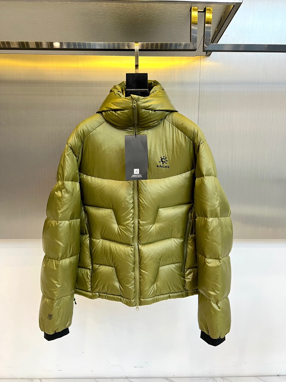 NO:598612,KAILAS-2025 Autumn and Winter New Product Down Jacket. Made of nylon windproof fabric to create a three-dimensional silhouette, filled with 95% white duck down to achieve high-standard warmth retention. The hooded design is paired with a detachable windproof skirt structure. The breathable zippers under the arms and the elastic tightening system on the cuffs form a three-dimensional protective network. The brand logo on the front chest is made of reflective material to enhance nighttime recognition, and the multi-dimensional quilting process ensures even distribution of down.  Passed the national down product quality certification, the olive green tone blends into the natural scene. The detachable parts meet the needs of multiple climates, and the underarm ventilation system copes with the heat emission of outdoor sports. From urban commuting to mountain hiking, it interprets Kailash's design philosophy of integrating professional outdoor technology into daily protection. 48-56 (model 173-140 pounds upper body size 50),,skirts,down jacket,hats,alexander wang19860909KAILAS-2025秋冬新品 羽绒服. 采用锦纶防风面料打造立体廓形,内充95白鸭绒实现高标准保暖性能,连帽设计搭配可拆卸防风裙结构,腋下透气拉链与袖口弹力收紧系统形成立体防护网络.前胸反光材质品牌标识增强夜间辨识度,多维度绗缝工艺确保羽绒均匀分布. 通过国家羽绒制品质量认证,橄榄绿色调融入自然场景.可拆卸部件满足多气候需求,腋下透气系统应对户外运动热量排放.从城市通勤到山地徒步,诠释凯乐石将专业户外科技融入日常防护的设计哲学.48-56（模特173-140斤上身50码）,,skirts,down jacket,hats,alexander wang,Men's clothing