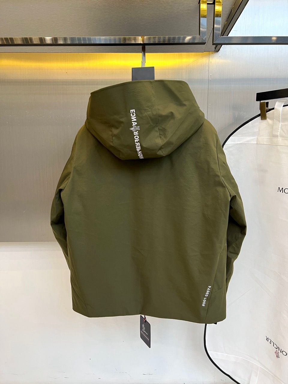 MON蒙口（高端鹅绒）、2025秋冬新品男士连帽羽绒外套，色调演绎现代户外机能风格。连帽设计搭配红白蓝三