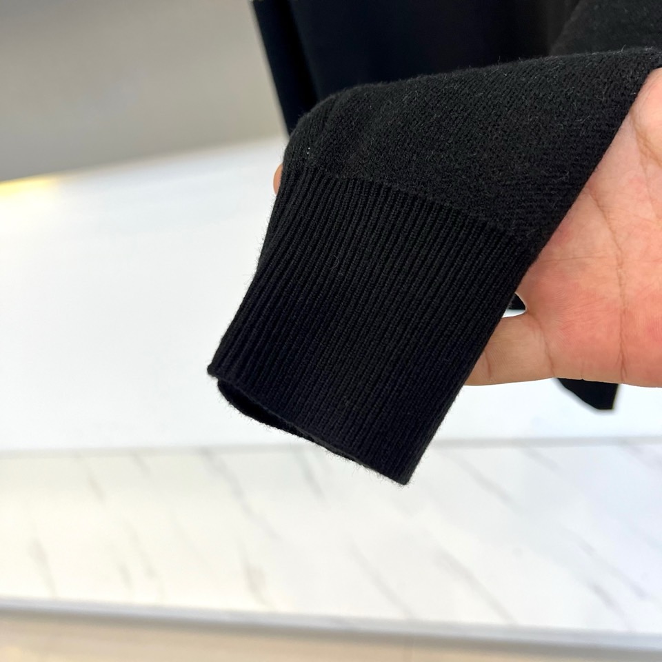 1v威登、2025秋冬新品毛衣以颠覆性设计诠释品牌经典基因。这款黑色圆领毛衣采用创新的双层结构设计，上半