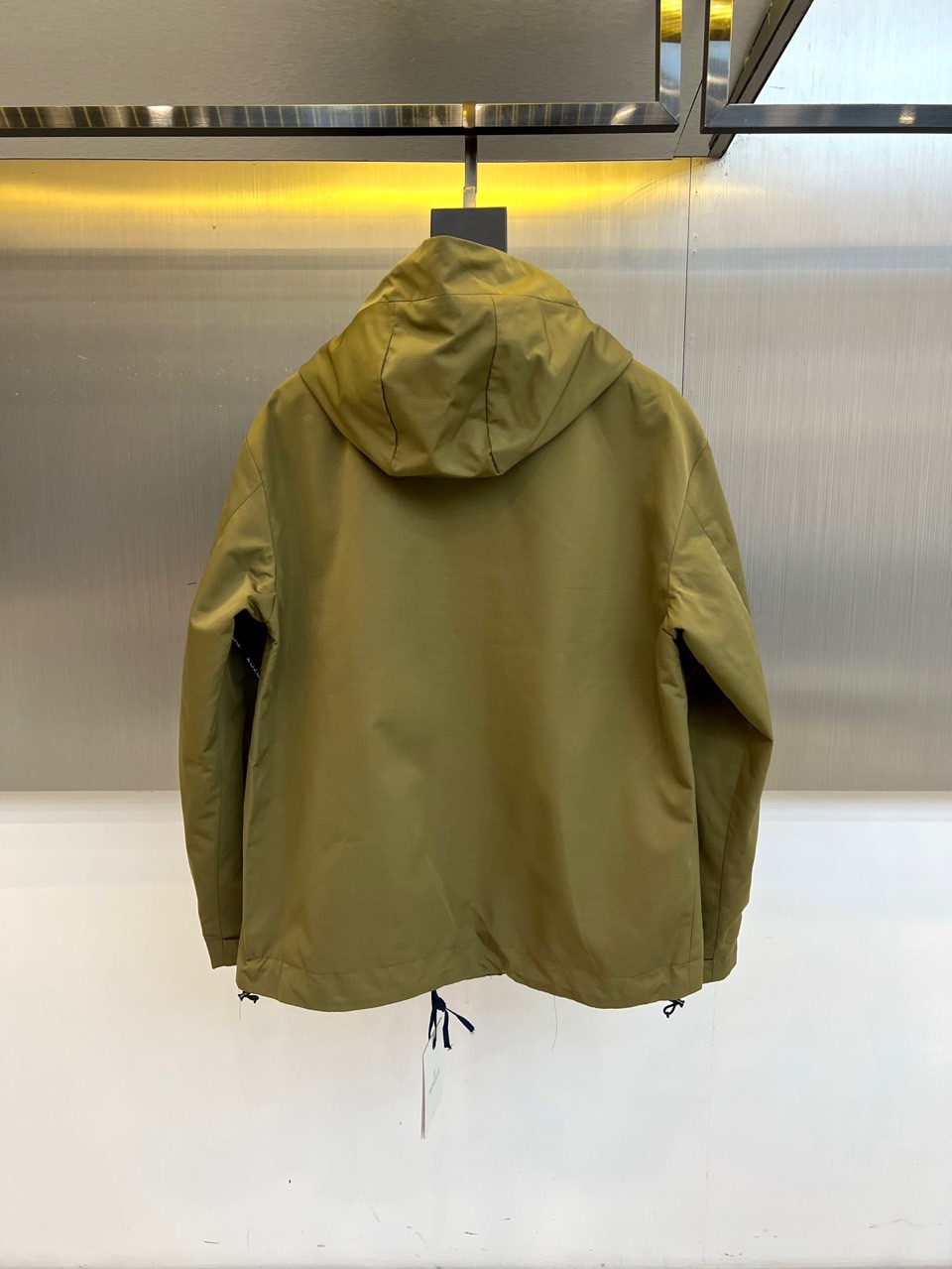 Mon蒙口、2025秋冬新品夹克，这款连帽夹克采用防风面料制作，顺滑的黑色拉链自下摆延伸至立领，左侧帽绳