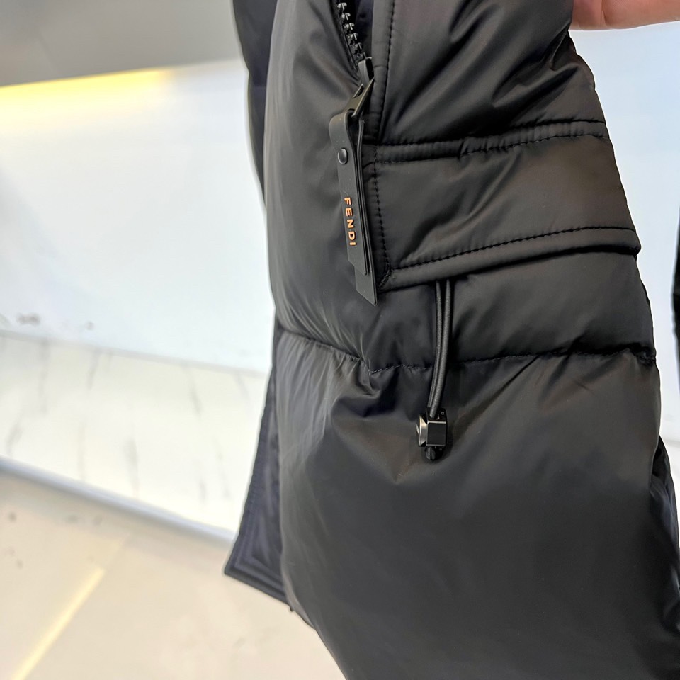 Fend芬迪（鹅绒）、2025秋冬新品羽绒服以经典黑色演绎奢华冬日美学。这款长款羽绒服采用连帽设计，帽檐