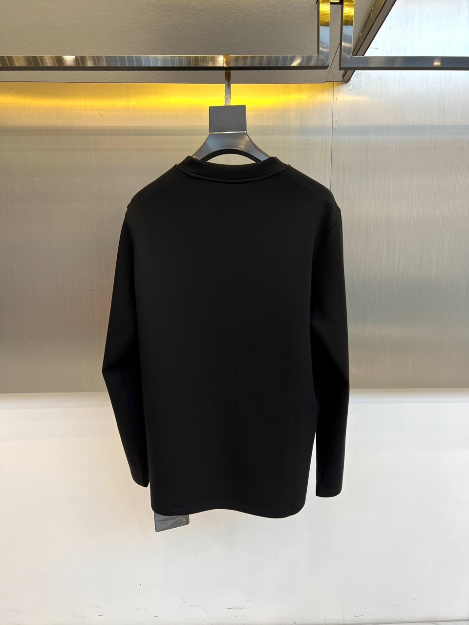 Prad普拉、普拉达2025秋冬新品莫代尔磨毛长袖上衣，以极简圆领设计诠释当代优雅风范。胸前点缀标志性倒