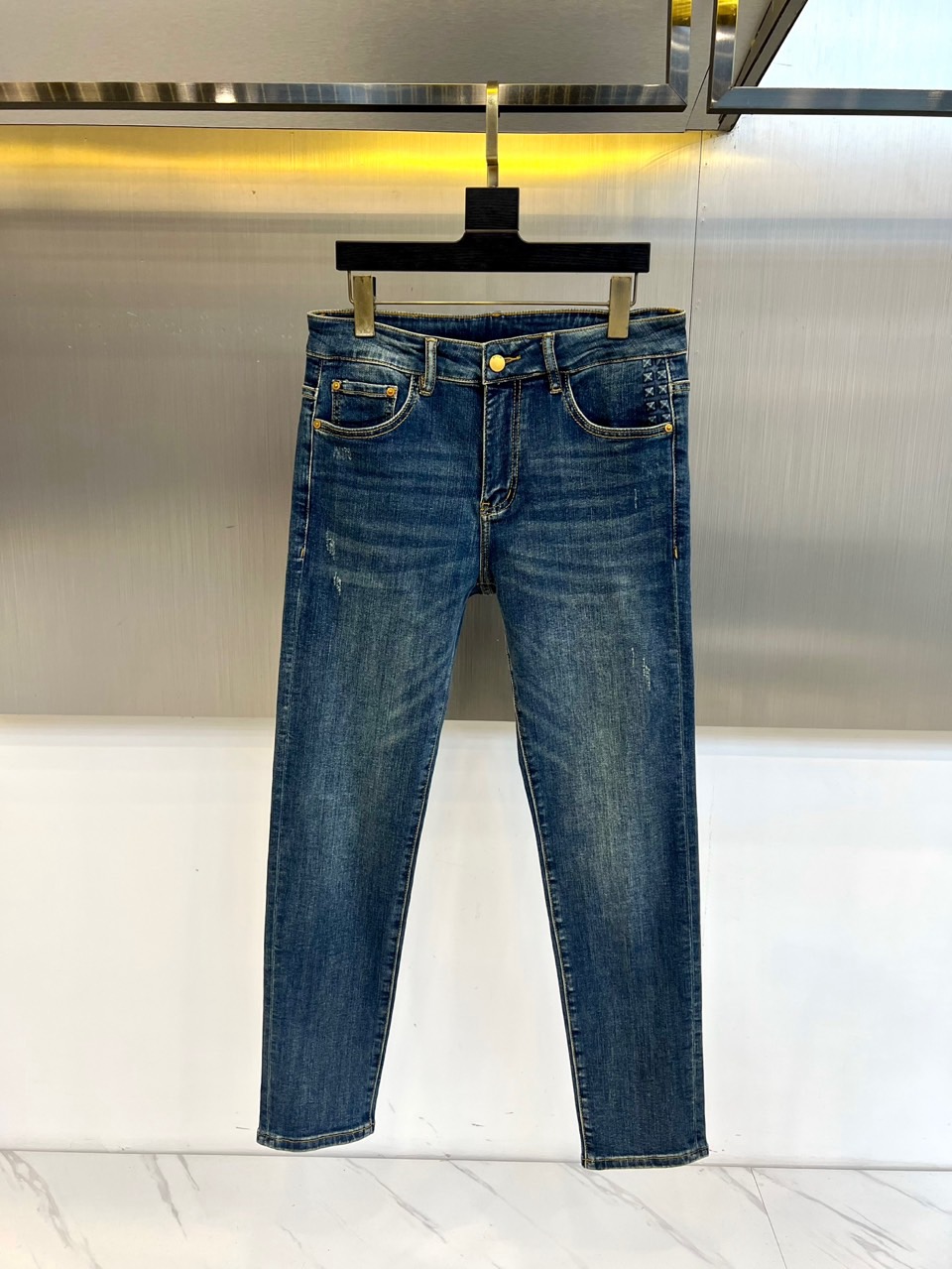 VT华伦天奴、2025秋冬新品深蓝色牛仔裤，以经典丹宁重塑现代奢华美学。后袋上方装饰标志性棕色菱格纹皮革