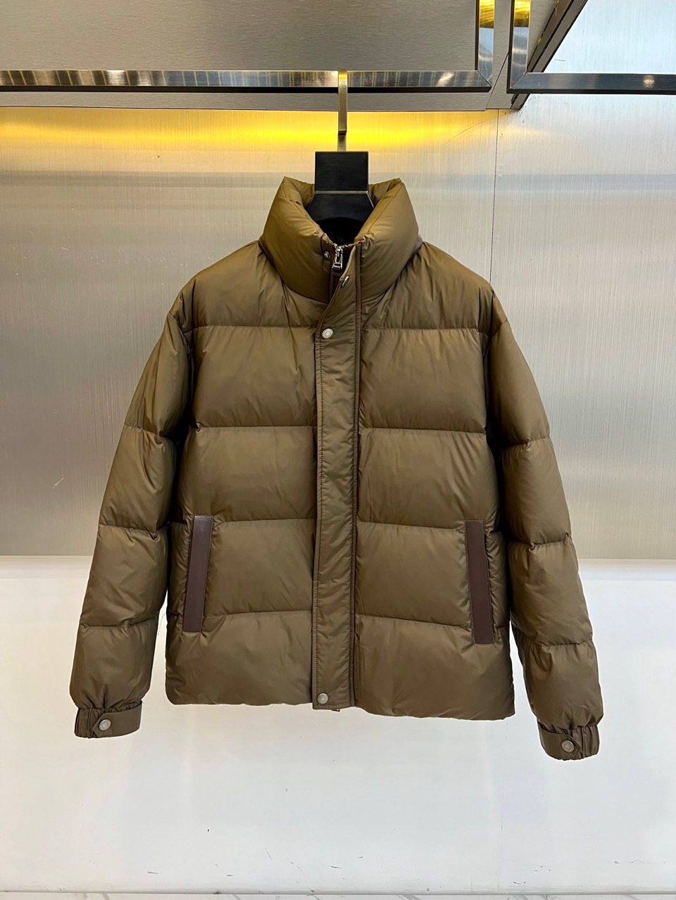 NO:650837,TF Tom Ford, the new men's down jacket for autumn and winter 2025, combines regular three-dimensional quilting lines to present a neat and crisp silhouette. The details highlight the extraordinary stand-up collar design and the metal buckles that can be pressed and adjusted on the cuffs to effectively lock in warmth; the front placket is double closed with zippers and snap buttons, which is convenient and practical; the pockets on both sides are innovatively integrated with dark leather splicing, adding rich layers of material collision in a low-key manner.  Its core warmth-keeping performance comes from its excellent inner filling, which is strictly selected from white duck down with a down content of up to 90%. Different sizes (48-58) correspond to precise down filling amounts of 155g to 180g, ensuring excellent heat-locking effect with a light body feel. The fabric and lining are made of high-density functional fibers, which are both windproof and durable.  The overall style perfectly combines the pragmatism of outdoor functions and the simple style of urban fashion. It can withstand severe cold wind and frost, and its neat tailoring and exquisite details are enough to cope with daily commuting and urban life. It is a smart choice to create diverse styles in autumn and winter. 48-56 (model is 173,143 pounds, upper body size 50),, tom ford, down jacket, alexander wang19860909TF汤姆福特、2025秋冬新品男士羽绒服,结合规整的立体绗缝线,呈现利落挺括的廓形.细节之处彰显不凡立领设计与袖口可按压调节的金属搭扣,有效锁住温暖；前襟采用拉链与按扣双重闭合,方便实用；两侧口袋创新融入深色皮质拼接,于低调中增添材质碰撞的丰富层次. 其核心保暖性能源于内在精良填充严格选用绒子含量高达90的白鸭绒,不同尺码（48-58）对应155g至180g的精准充绒量,确保轻盈体感下的卓越锁温效果.面料与里料均采用高密度功能性纤维,兼顾防风与耐用. 整体风格完美融合了户外机能的实用主义与都市时尚的简约格调.它既能抵御严寒风霜,其利落剪裁与考究细节又足以从容应对日常通勤与都市生活,是塑造秋冬多元造型的智慧选择.48-56（模特173,143斤上身50码）,,tom ford,down jacket,alexander wang,Men's clothing
