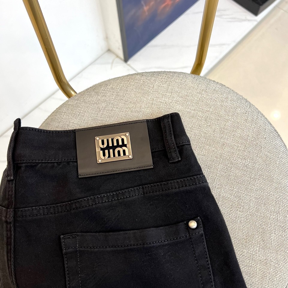 Miu Miu 2025秋冬新品黑色牛仔裤，以精裁廓形演绎品牌标志性的甜酷美学。款式采用高腰直筒剪裁，裤
