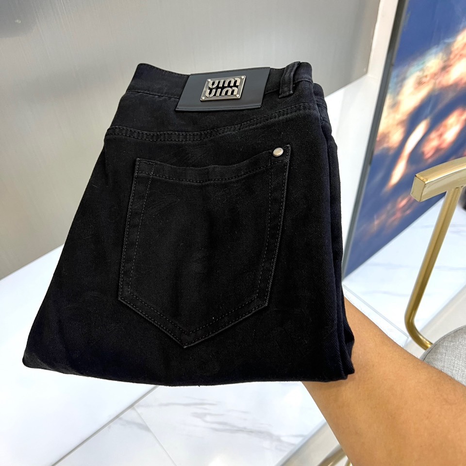 Miu Miu 2025秋冬新品黑色牛仔裤，以精裁廓形演绎品牌标志性的甜酷美学。款式采用高腰直筒剪裁，裤