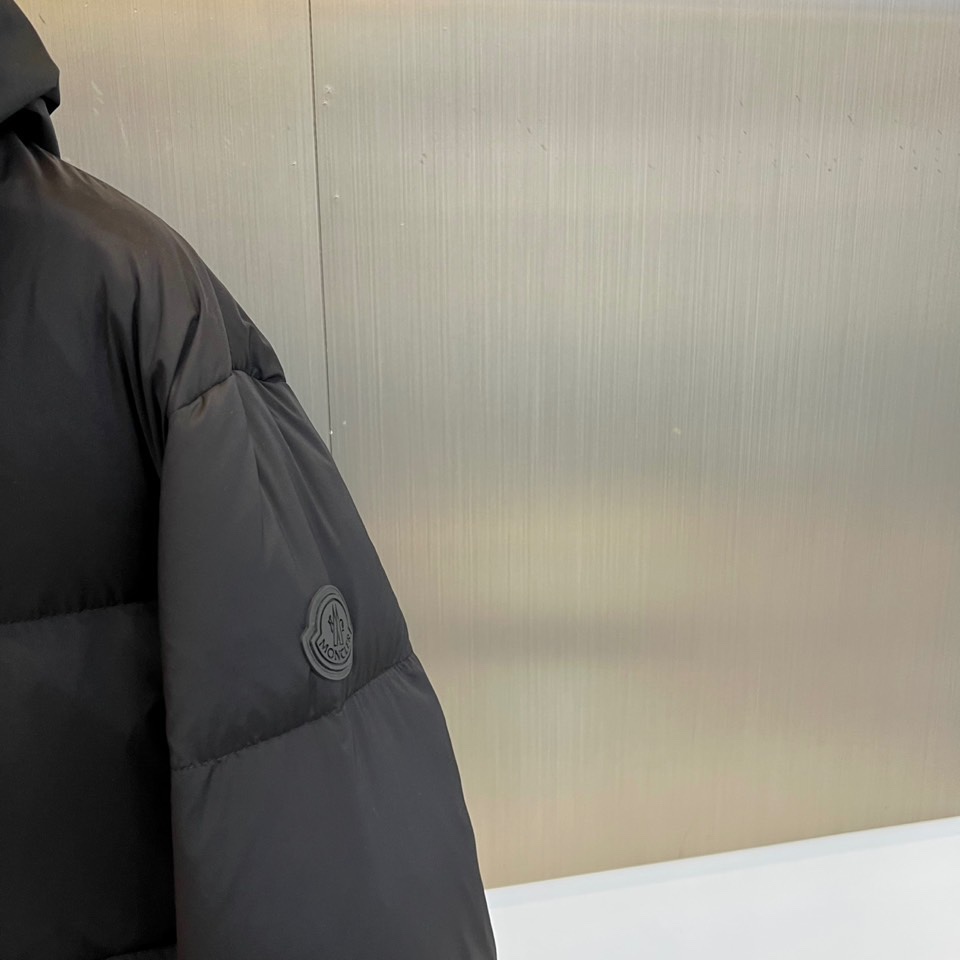 蒙口、2025秋冬新品羽绒服，这款连帽羽绒服采用规整的方块绗缝工艺，勾勒出立体饱满的轮廓线条。黑色拉链自