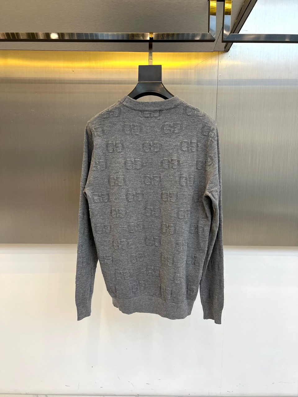Gucc古驰、2025秋冬新品灰色毛衣以经典GG压纹图案演绎意式奢华美学。这款圆领毛衣采用宽松版型设计，