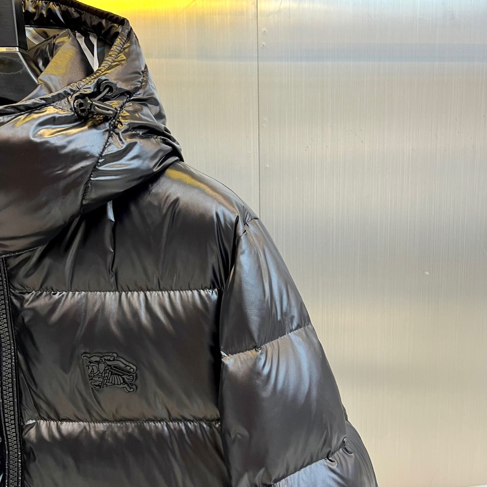 Bur巴宝莉、2025秋冬新品格纹羽绒服，以经典黑色演绎英伦户外美学。款式采用连帽设计搭配可调节抽绳系统