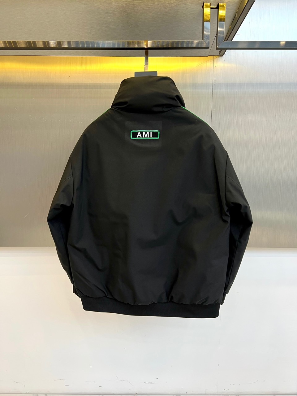 Ami 2025秋冬新品羽绒服，以简约立领设计融合运动美学，重新定义都市冬日时尚。款式采用利落的拉链开合