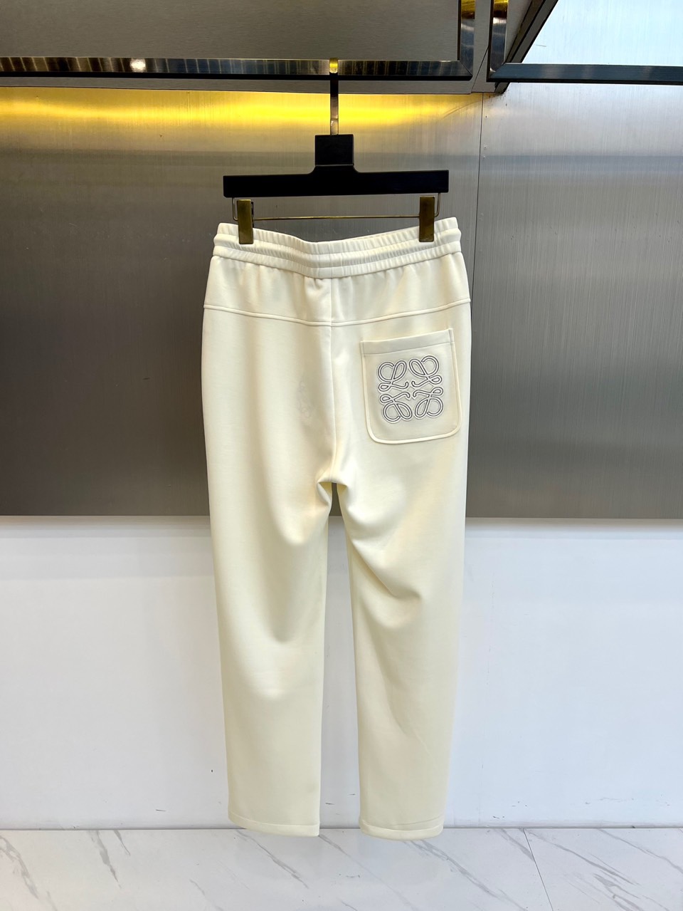 Lowe罗意威、2025秋冬新品休闲裤，以超柔面料重塑日常舒适的定义。本款采用柔和米白色调，呈现简约高级