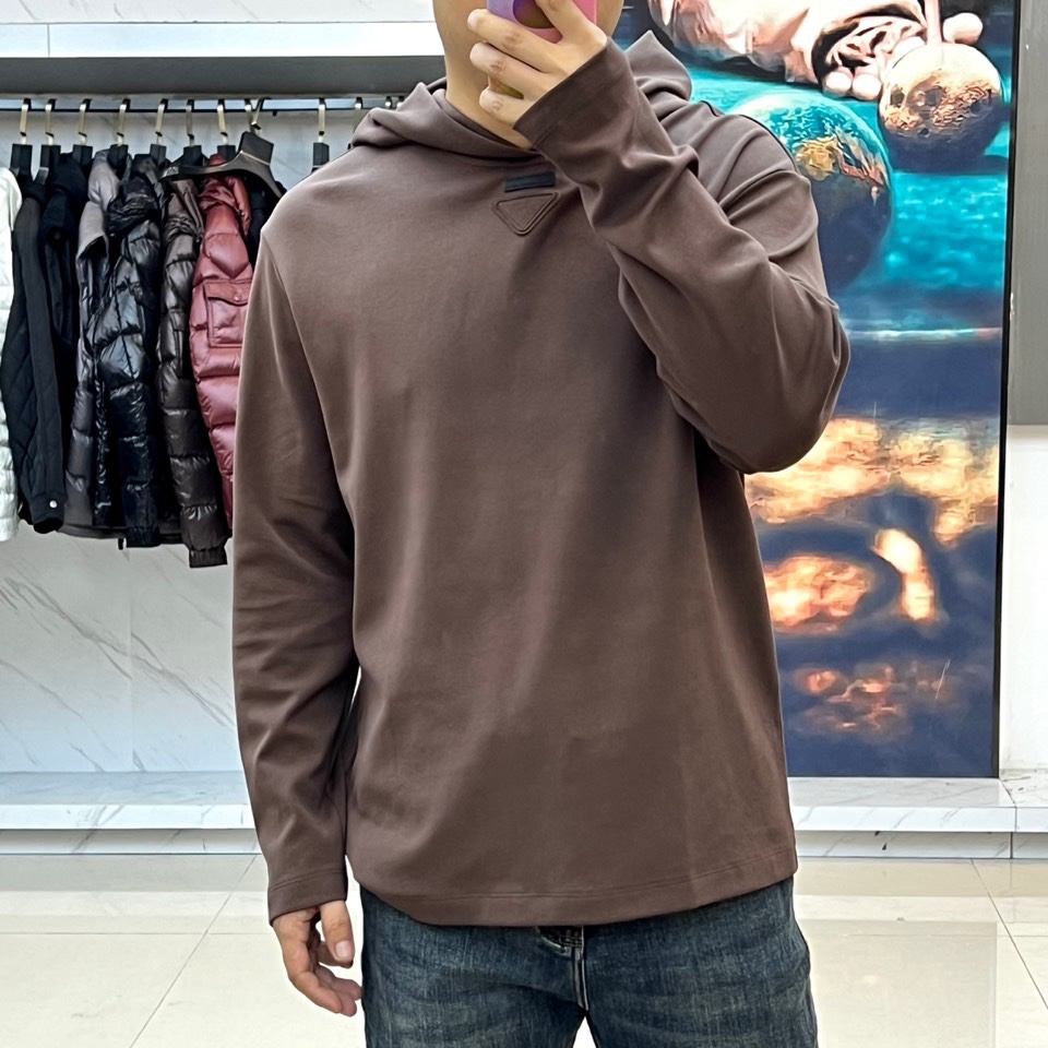 Prad普拉达、2025秋冬新品白色连帽上衣，以极简设计诠释现代奢华运动风范。款式采用宽松立体的剪裁，连