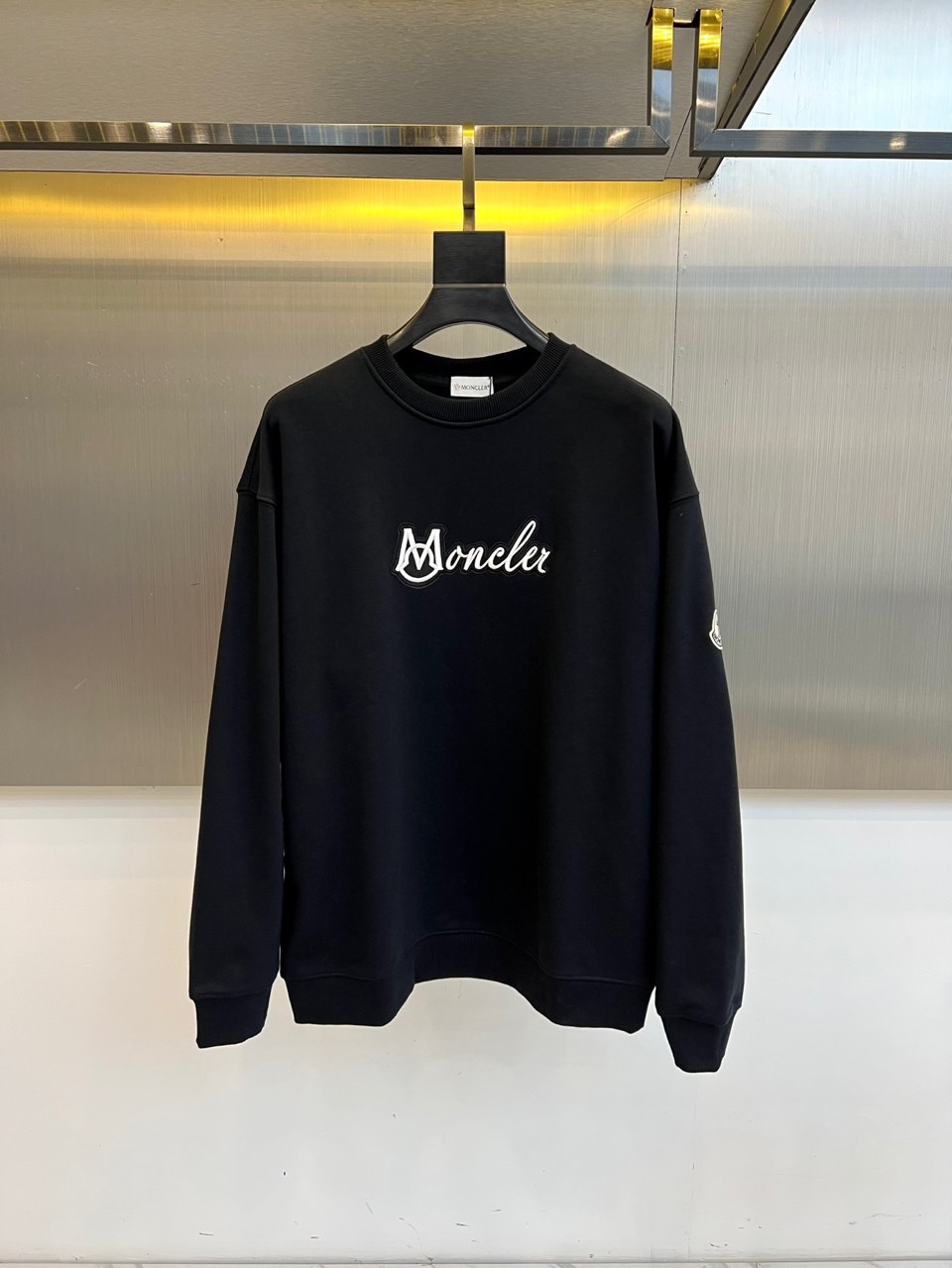 Mon蒙口、2025秋冬新品卫衣，款式采用经典圆领廓形，剪裁宽松流畅，确保穿着时的自在舒适度。正面饰有醒