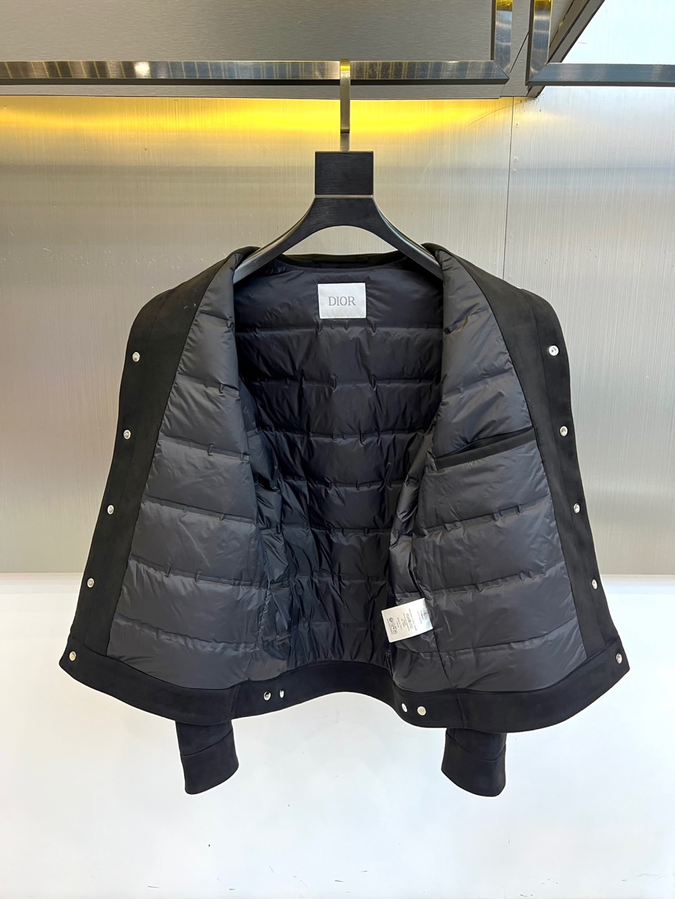 Dio迪奥、2025秋冬男士新品羽绒服外套。以质感棕色麂皮夹克诠释经典魅力。款式采用利落的翻驳领设计，勾