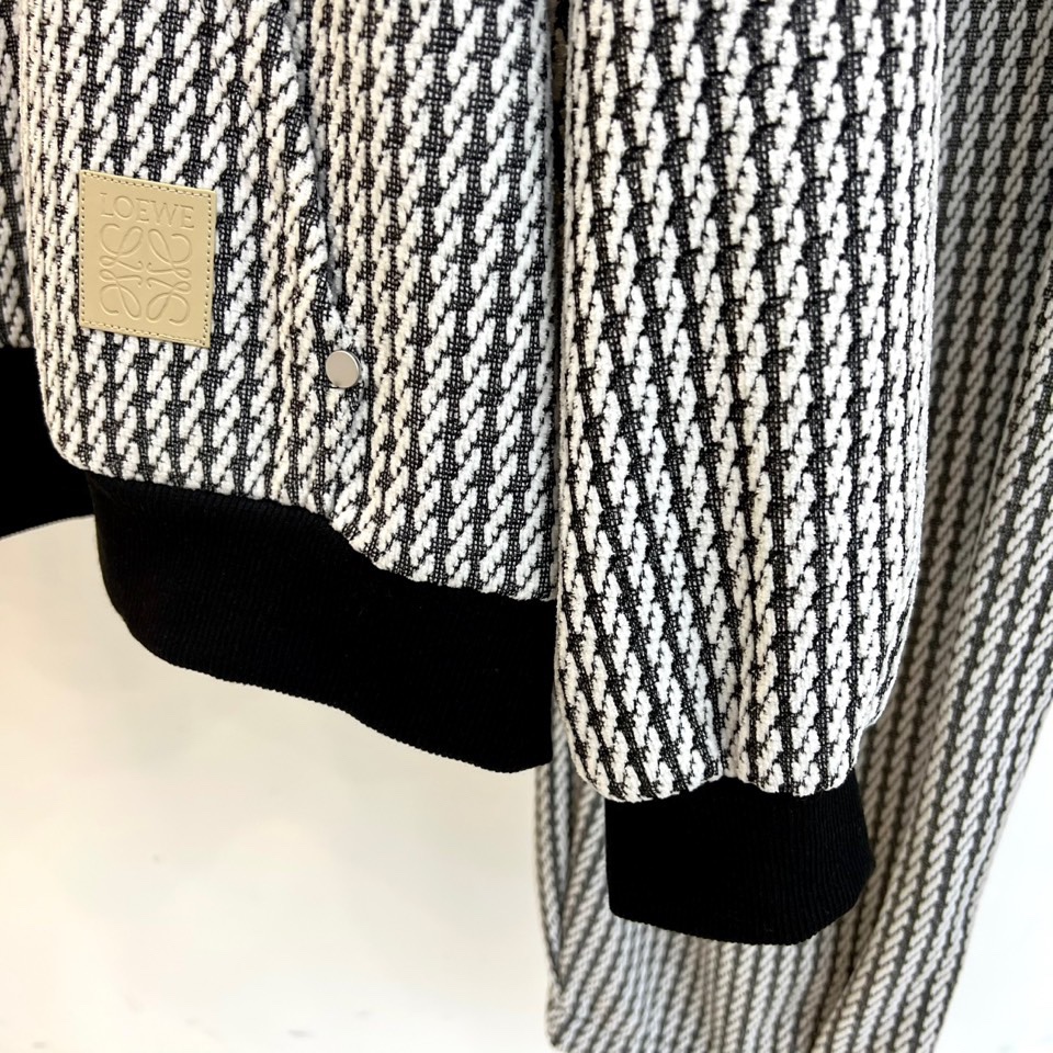 罗意威（LOEWE）套装，以经典的黑白千鸟格纹贯穿始终，将复古优雅与现代时尚感精妙结合。连帽上衣的千鸟格