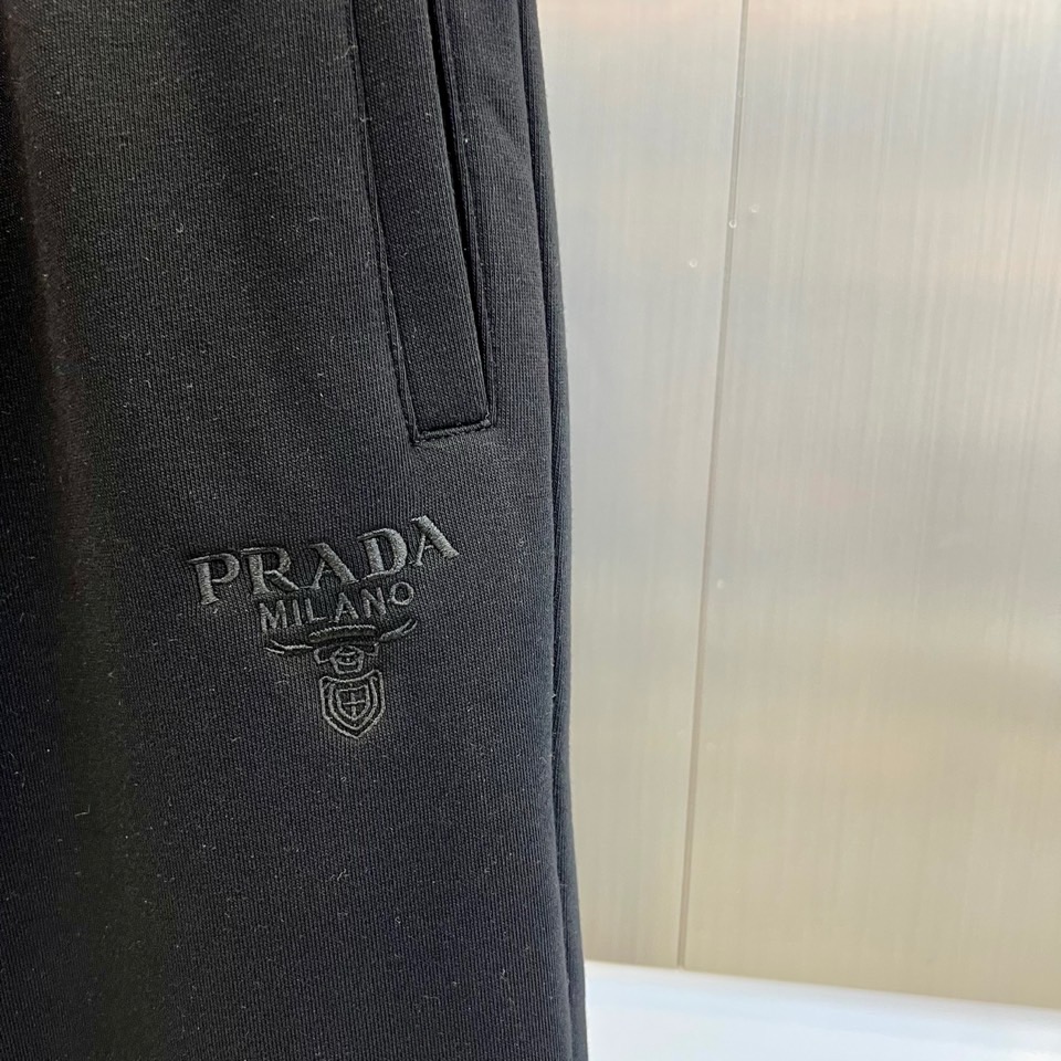 Prad普拉达、2025秋冬新品加绒休闲卫裤，以简约流畅的直筒剪裁，诠释当代休闲服饰的高级质感。裤腰采用
