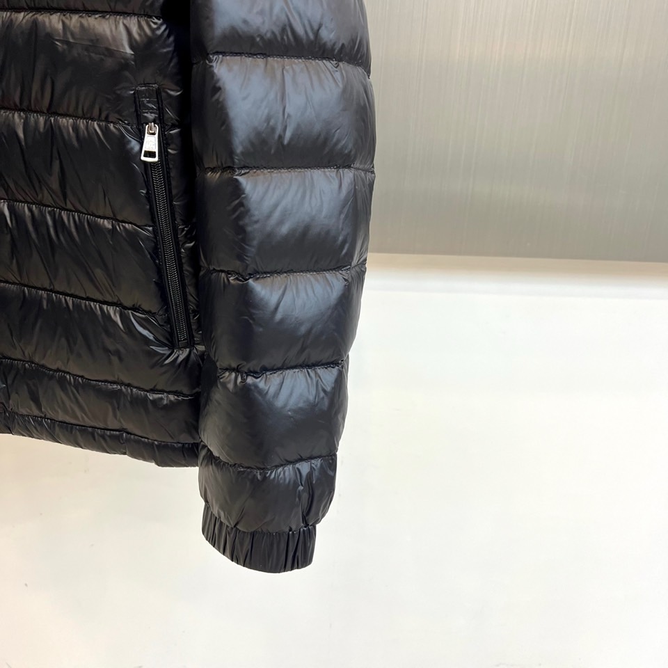 Mon蒙口、2025秋冬新品黑色羽绒服，以经典黑色演绎从高山到都市的极简奢华美学。款式采用利落立领设计，