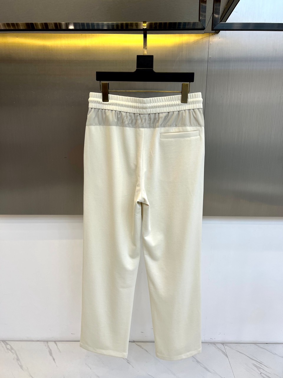 Bur巴宝莉、2026春夏男士休闲裤，以流畅的直筒廓形诠释都市松弛风尚。其核心在于高腰处的松紧抽绳设计，