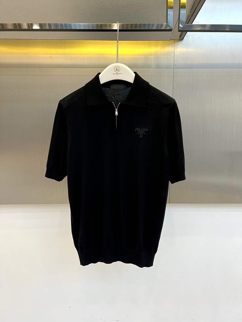 Prad普拉达、2026春夏新品短袖Polo衫，以极简廓形重塑经典运动风尚。短袖设计搭配挺括翻领，前襟半