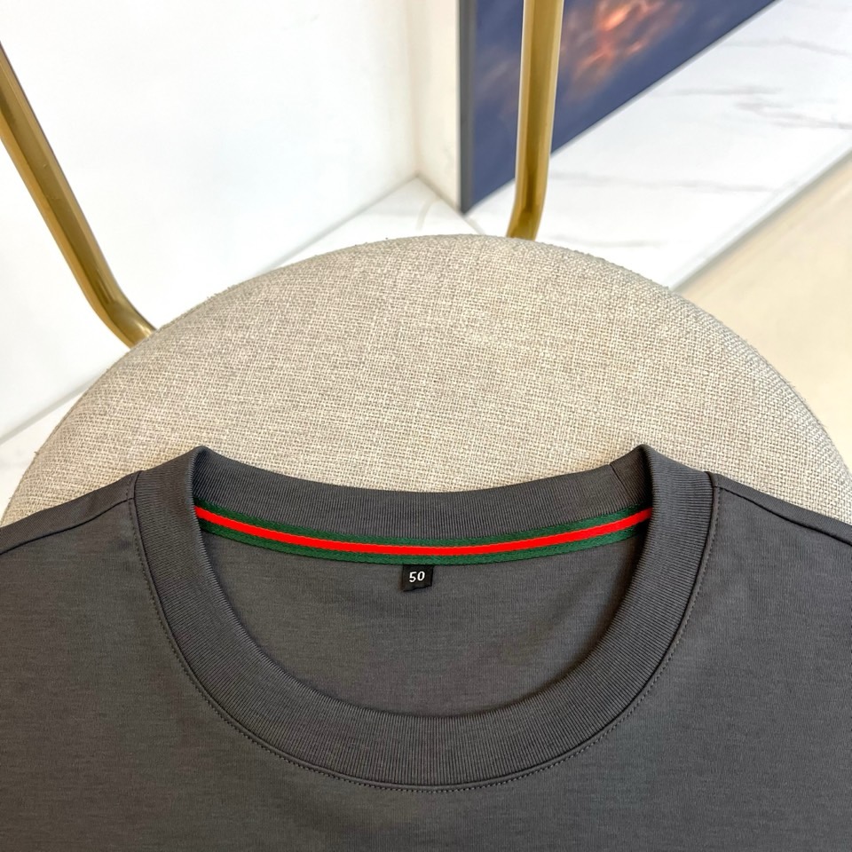 Gucc古驰、2026春夏新品短袖T恤，以纯色为基底，胸前采用立体压花工艺呈现品牌字母标识，简约中暗藏精