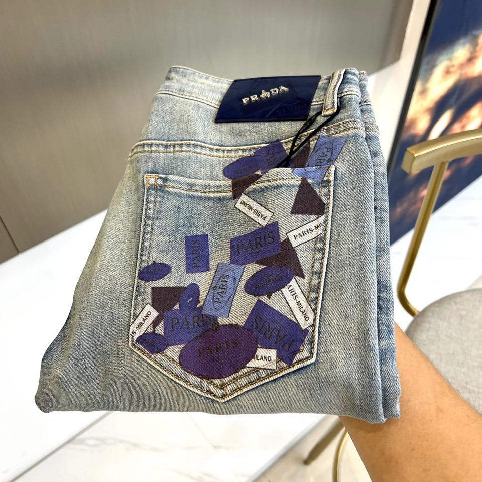 NO:866555,Prad, 2026 spring and summer new jeans, combine neat tailoring with artistic printing to redefine urban casual style. Washed denim base, retro texture with casual accent; the back pocket is covered with geometric patches, with brand words scattered at random.  , the letters and color blocks collide to create a deconstructed aesthetic, which not only continues the brand's genes, but also injects a pioneering trend attitude. The leather label on the waist is embellished with a metal logo, which low-key highlights the recognition of the luxury brand; the stitching is neat and neat, and the craftsmanship can be seen in the details. The loose straight fit is suitable  With a variety of body shapes, it exudes a relaxed aura when walking. Whether it is paired with a minimalist white T to create a sense of daily luxury, or layered with a short shirt to highlight the layers, it can be easily controlled. From urban commuting to weekend roaming, this pair of jeans perfectly balances artistic prints and practical silhouettes, making the spring and summer wardrobe both fashionable and comfortable. It is a must-have item for fashion players who pursue texture and creativity this season. 29-38 (no 37),, prada, prada, jeans, shirts,19860909Prad普拉达、2026春夏新品牛仔裤,以利落剪裁融合艺术感印花,重新定义都市休闲风.水洗丹宁基底,复古质感中透着随性腔调；后袋布满几何贴片,错落呈现品牌字样,字母与色块碰撞出解构美学,既延续品牌基因,又注入先锋潮流态度.腰头皮质标牌缀金属logo,低调彰显奢牌辨识度；缝线工整利落,细节处见工艺质感.宽松直筒版型适配多元身形,行走间流露松弛气场.无论是搭配极简白T打造日常高级感,还是叠穿短款衬衫凸显层次,都能轻松驾驭.从都市通勤到周末漫游,这条牛仔将艺术印花与实用廓形完美平衡,让春夏衣橱兼具时髦辨识度与舒适体验,是追求质感与创意的时尚玩家的本季必入单品.29-38（无37）,,prada,prada,jeans,shirts,,Men's clothing