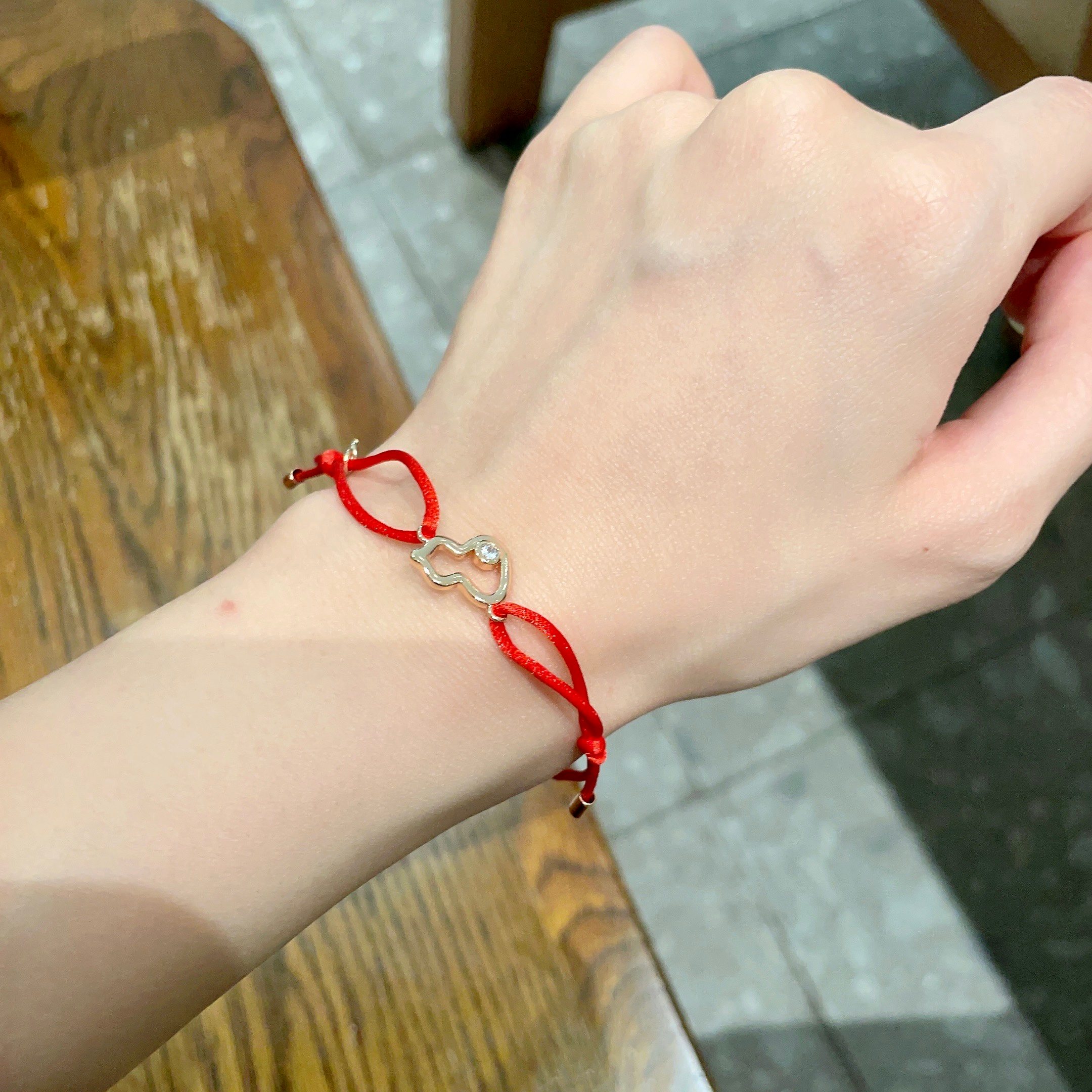 Qeelin Kirin Mini Gourd bracelet red cord gold-toned metal clear diamond accent adjustable sliding knot fits 15-19cm wrist