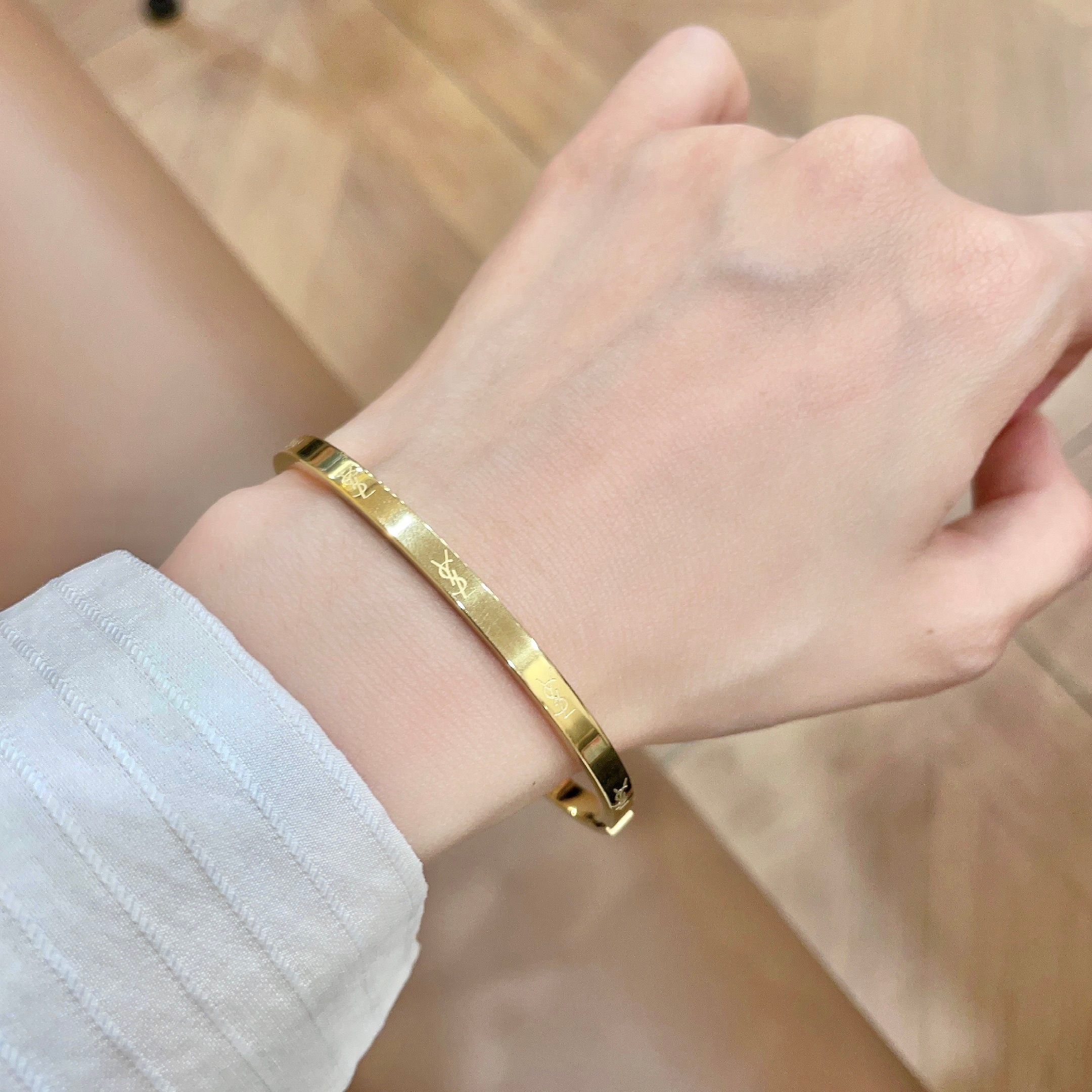Saint Laurent Cassandre Logo Engraved Hinged Bangle bracelet 18K gold tone metal no accent stones 17cm inner circumference