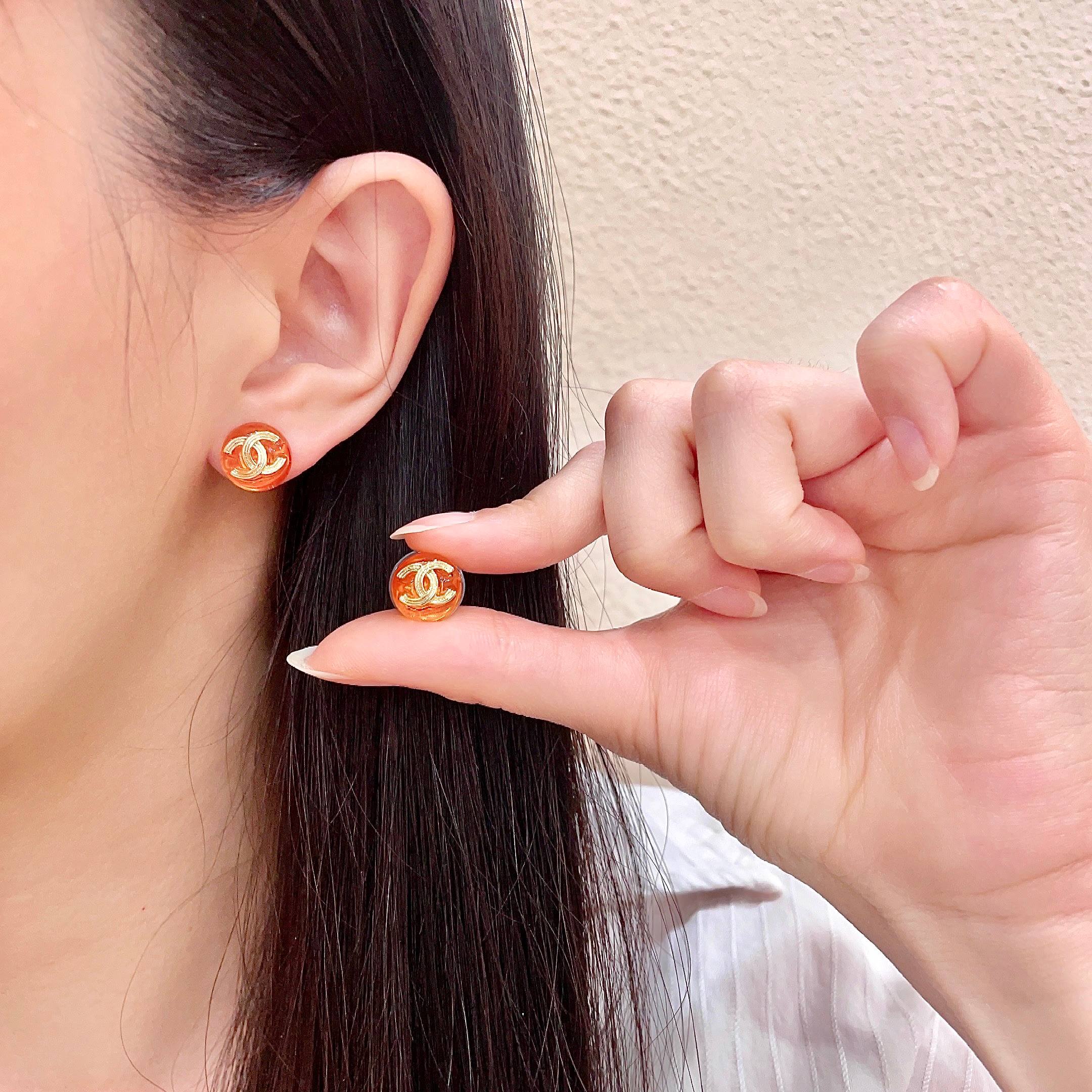 Chanel CC Logo Round Stud Earrings earrings gold-tone metal translucent orange resin 1 2cm diameter