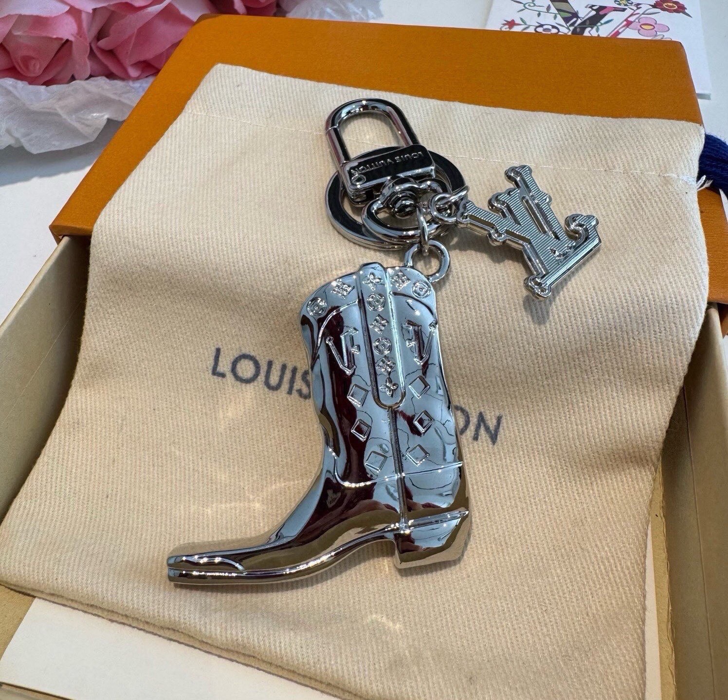🔥LV钥匙扣 靴子挂件车钥匙挂饰，品牌经典标识巧妙嵌入链环之间。LV字母装饰于一端优雅垂坠，弹簧扣实现轻松固定，为裤装或