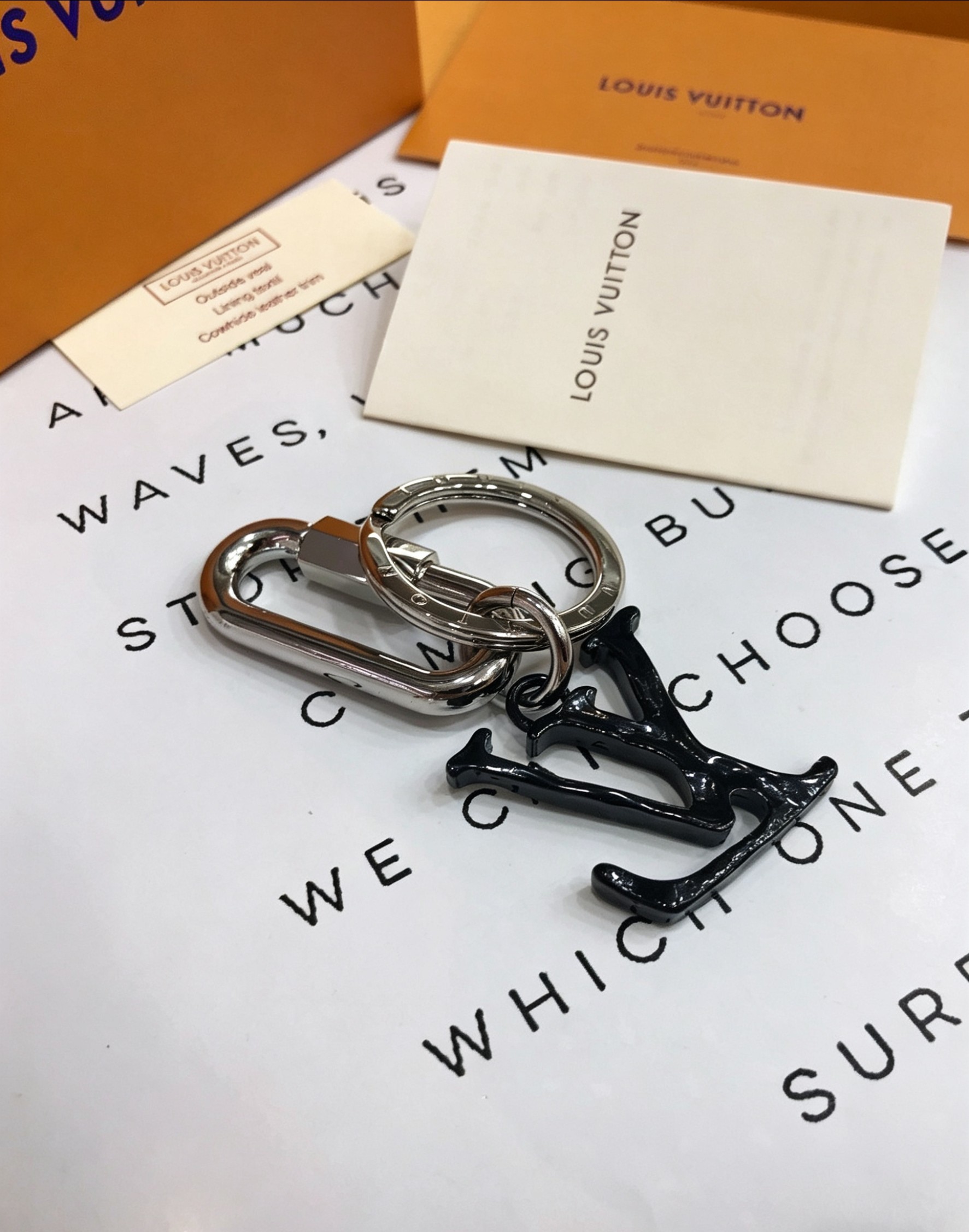 Louis Vuitton 本季腰带上的醒目搭扣化身为 1V Shape 包饰与钥匙扣 是一款标新立异的品牌标识