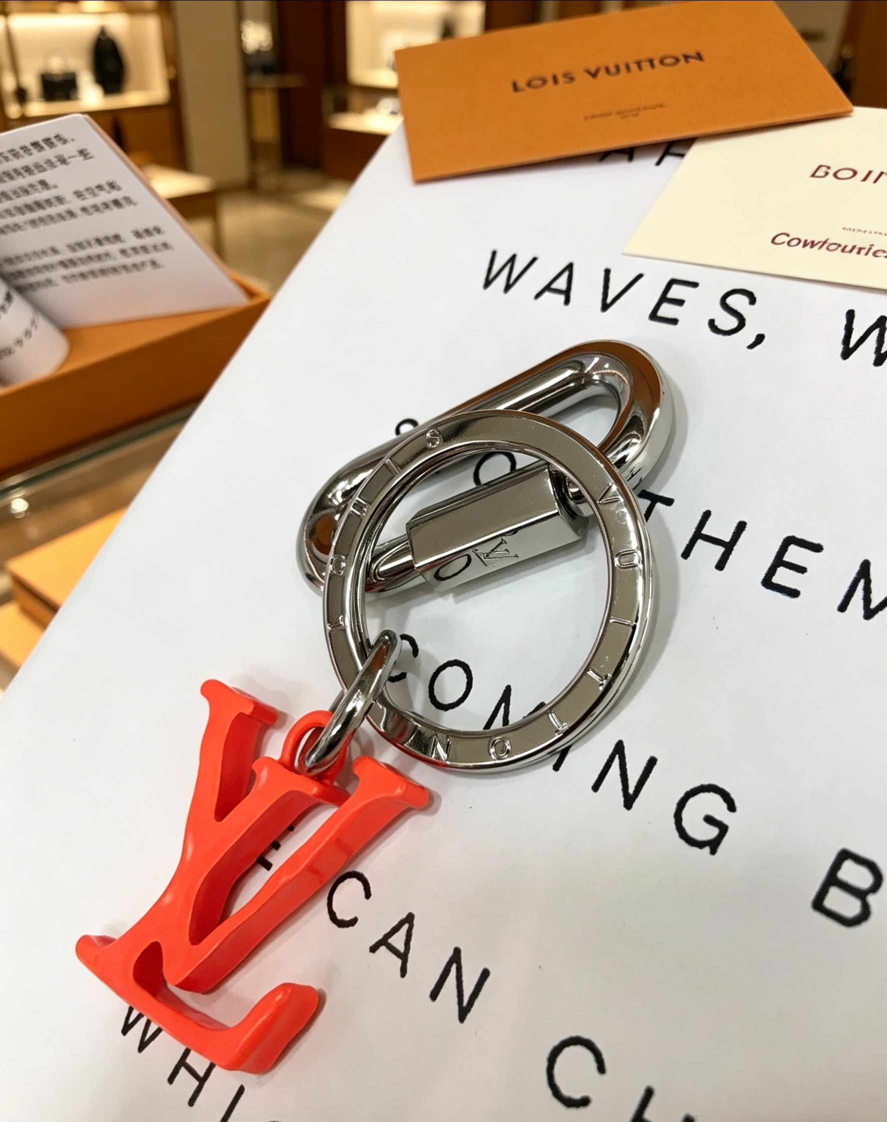 Louis Vuitton 本季腰带上的醒目搭扣化身为 1V Shape 包饰与钥匙扣 是一款标新立异的品牌标识