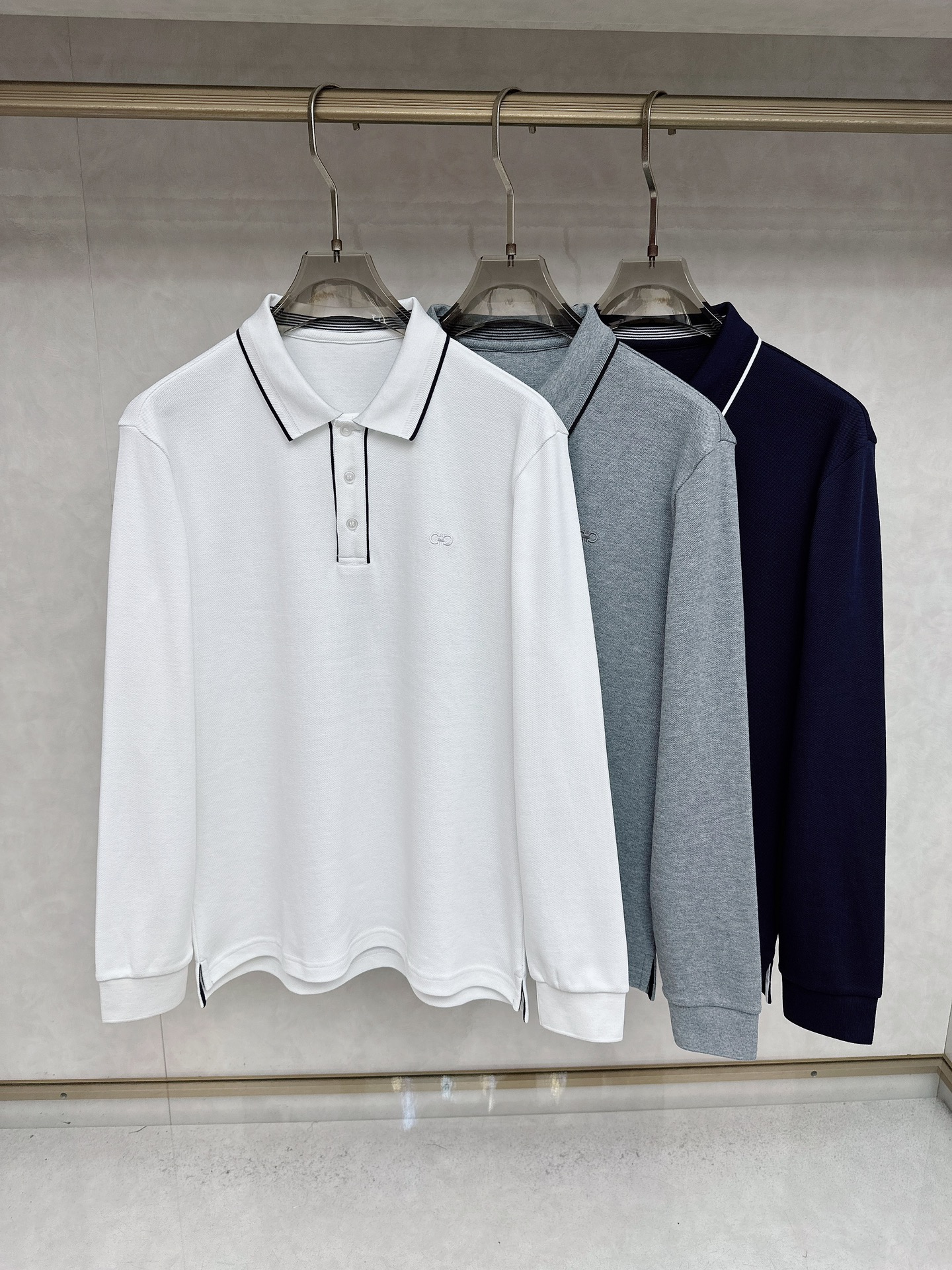 NO:568300,Ferragamo's 2025 early autumn new Ferr*gamo horseshoe embroidered logo high-end business casual POLO shirt. Born because of classics, the signature item that must be released every season is reincarnated in every season. The new season still continues the design tone of the house, which is generally undifferentiated. Striped elements are mixed in the details, which is very fashionable, elegant, age-reducing and retro. It forms an aesthetic contrast visually and can easily highlight the elements of temperament and taste!  We provide customers with high-end imported ready-made custom-woven pique fabrics, which are extremely luxurious and special materials. The fabric properties are all of the best. The stripes are made of exquisite yarn-dyed technology. The fabric has high gloss, the mesh structure is delicate and natural, and it has perfect comfort and breathability. The tactile experience is self-evident, and you can enjoy the ultimate luxury!  The details are exquisite and the appearance is first-class. The three-button placket closure, small lapel design, and the iconic Gancio horseshoe embroidery on the chest are quite exquisite and have a soul-like existence, highlighting the noble brand identity!  The upper body effect is excellent, and it can be mixed and matched for commuting or leisure. It can easily interpret the ultra-stylish urban elite feel. It is a highly controllable item!  Color Navy White Gray Size M L  XXL code: bust 118cm - dress length 73cm - shoulder width 49cm - sleeve length 64cm XXXL code: bust 122cm - dress length 74cm - shoulder width 50cm - sleeve length 65cm,,ferragamo,ferragamo,alexander wang19860909菲拉格慕 2025早秋新款Ferr*gamo马蹄刺绣标识高端商务休闲POLO衫马球衫.因经典而生,每季必出的招牌单品,在每一季轮回,新一季仍然延续了家的设计基调,大体无差异化,在细节上面混搭了条纹元素,非常时髦优雅减龄且复古,在视觉上形成审美反差,极易凸显气质与品位的元素！客供高级进口成衣定织珠地面料,极为奢华特殊的材质,面料属性皆为上乘,条纹采用精湛的色织工艺打造而成,面料光泽度极高,网眼结构细腻自然,舒适性与透气性完美兼备,触感体验不言而喻,奢华极致享受！细节精湛考究,品相一流,三扣门襟开合,小翻领设计,胸前标志性的 Gancio 马蹄刺绣体点缀,颇为精致,属于灵魂式的存在,彰显了高贵的品牌身份！上身效果出色,即通勤亦休闲混搭,可以轻松诠释出超具型格的都市精英感,属于驾驭度极高的单品！ 颜色藏青色 白色 灰色 尺码M L XL XXL XXXL 尺码数据 M码:胸围106cm-衣长70cm-肩宽46cm-袖长61cm L码:胸围110cm-衣长71cm-肩宽47cm-袖长62cm XL码:胸围114cm-衣长70cm-肩宽48cm-袖长63cm XXL码:胸围118cm-衣长73cm-肩宽49cm-袖长64cm XXXL码:胸围122cm-衣长74cm-肩宽50cm-袖长65cm,,ferragamo,ferragamo,alexander wang,Men's clothing